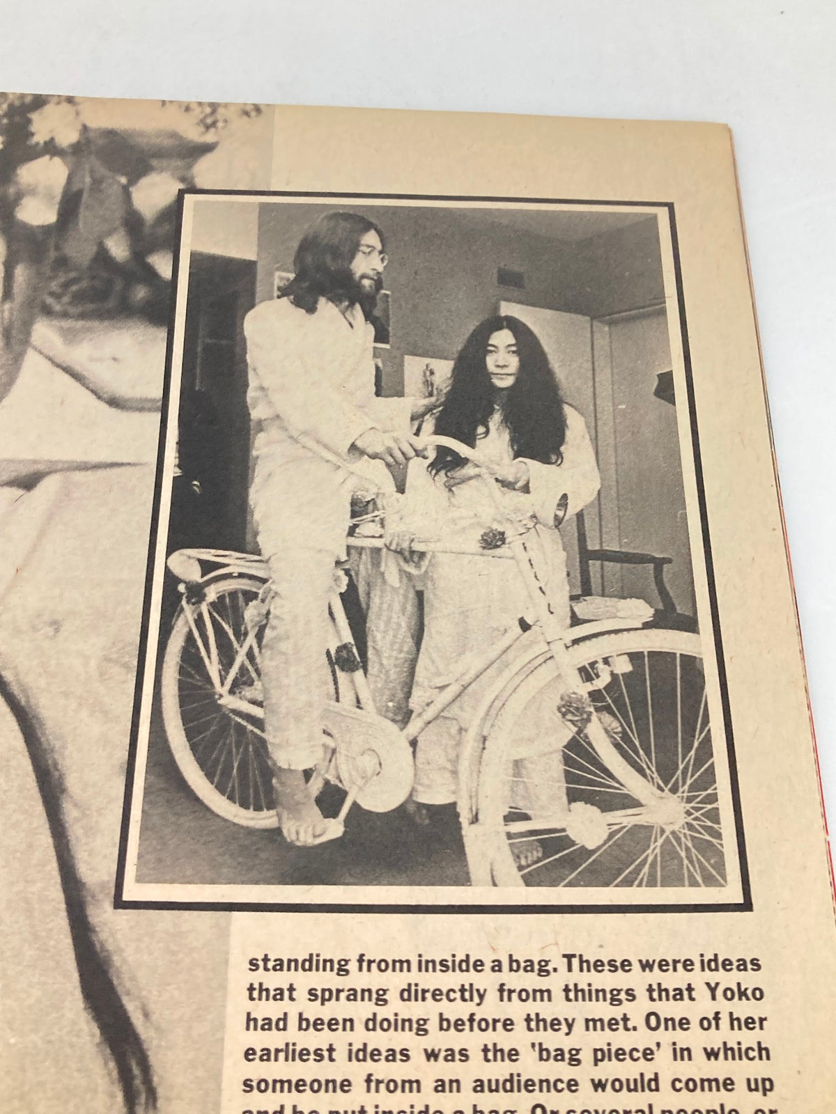 Image from the 1981 John Lennon Beatles Memory Book showing John Lennon and Yoko Ono interacting playfully, highlighting their artistic partnership.