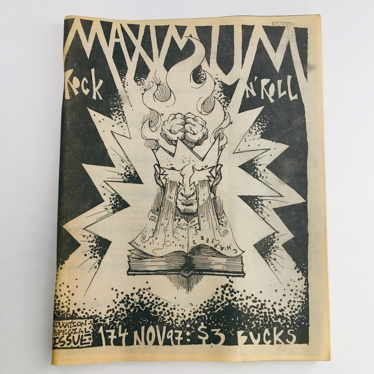 Cover of Maximum RocknRoll Magazine November 1997 Issue #174 featuring artwork of a punk-inspired figure with a flaming head, striking design elements and the issue number.