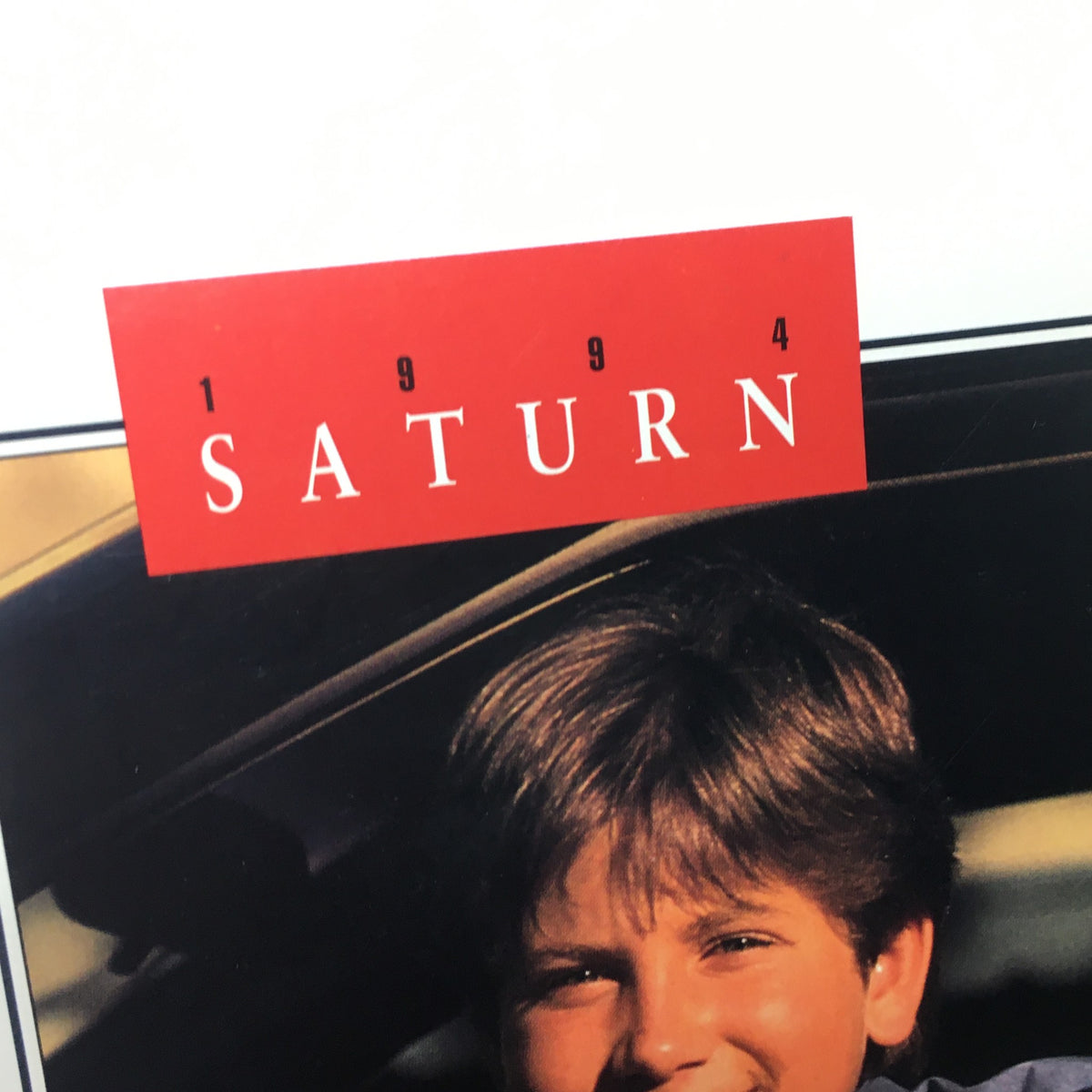 Close-up of the title from the 1994 Saturn SL-1 SW-1 SW-2 Dealership Car Auto Brochure Catalog, showcasing the iconic branding.