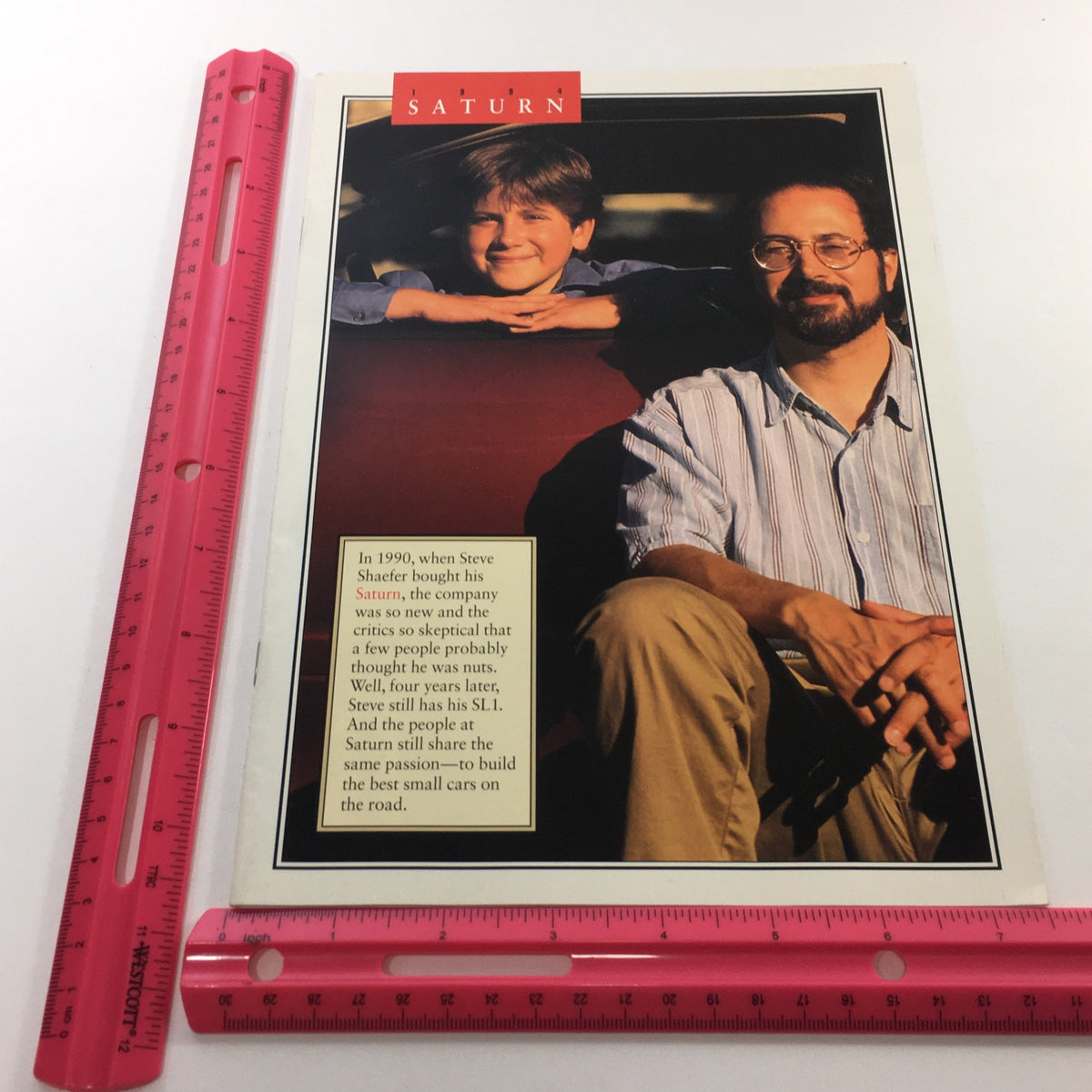 Front cover of the 1994 Saturn SL-1 SW-1 SW-2 Dealership Car Auto Brochure Catalog featuring a man and a boy with a Saturn vehicle, highlighting customer experience.