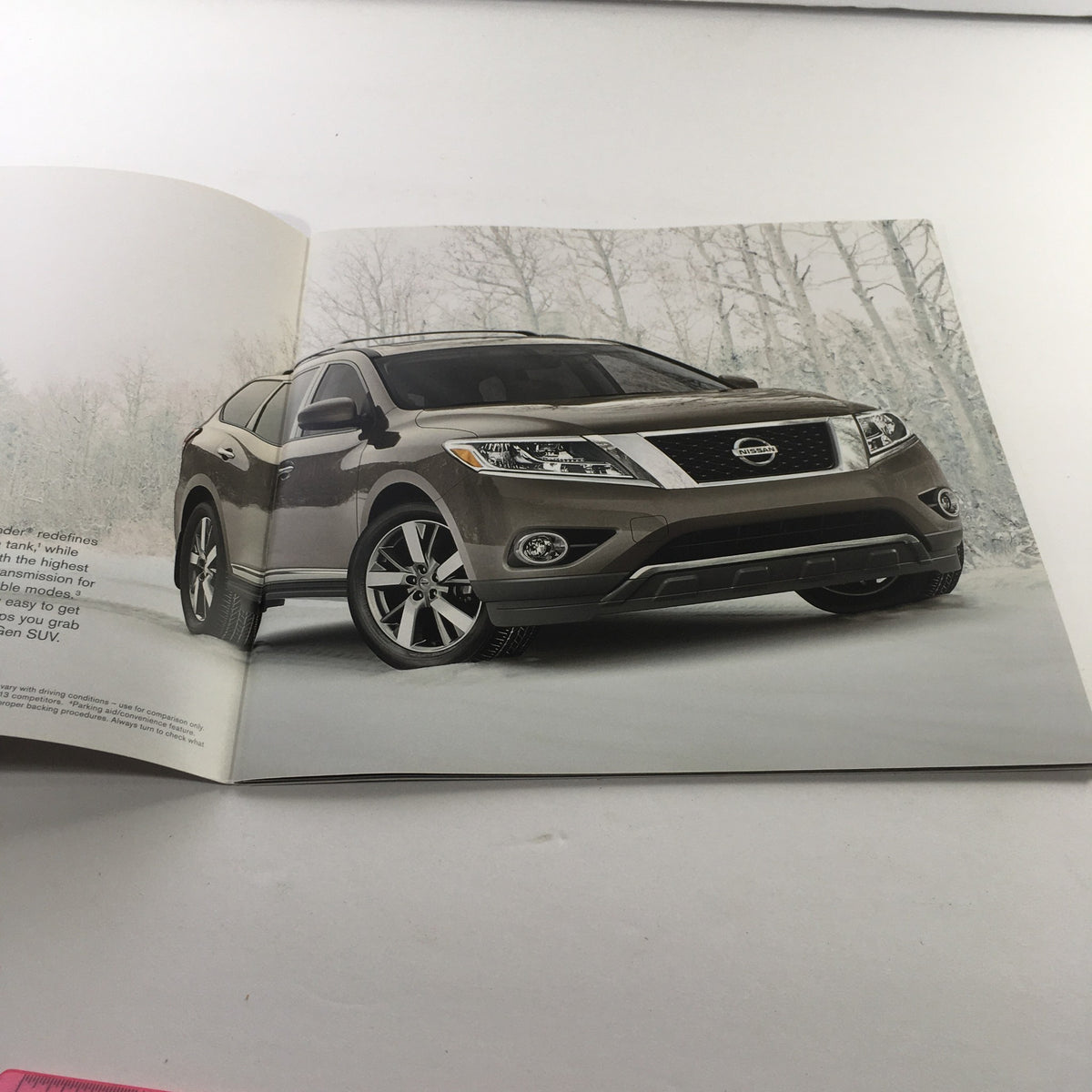 Interior page of the 2014 Nissan Pathfinder SUV Dealership Car Auto Brochure Catalog showcasing a brown Pathfinder in a snowy environment.