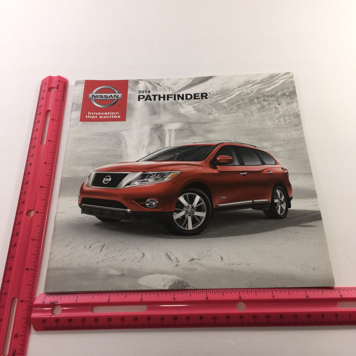 Front cover of the 2014 Nissan Pathfinder SUV dealership brochure showcasing the vehicle with visual appeal and design highlights.
