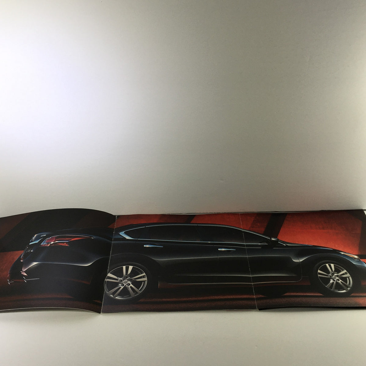 Inside page of the 2015 Nissan Altima Sedan Dealership Car Auto Brochure Catalog displaying the profile of the car against a stylish background.