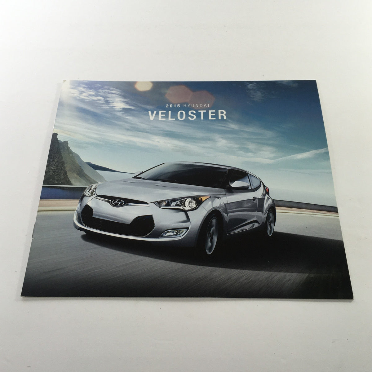 2015 Hyundai Veloster Dealership Car Auto Brochure Catalog cover showcasing the Veloster with a scenic background.