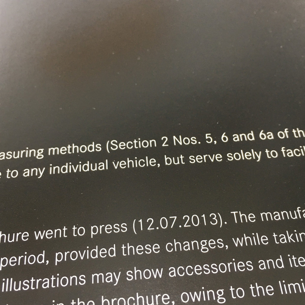 Information page from the 2013 Mercedes-Benz AMG Portfolio Dealership Car Auto Brochure Catalog explaining manufacturing details and disclaimers.