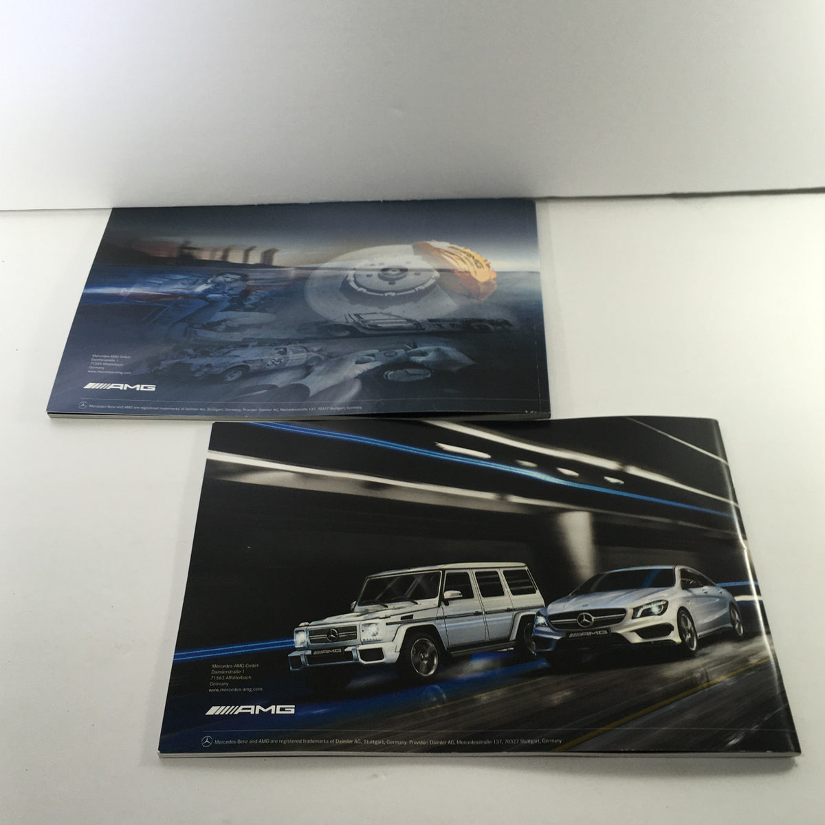 2013 Mercedes-Benz AMG Portfolio Dealership Car Auto Brochure Catalog showcasing front and back covers with dynamic automotive illustrations.