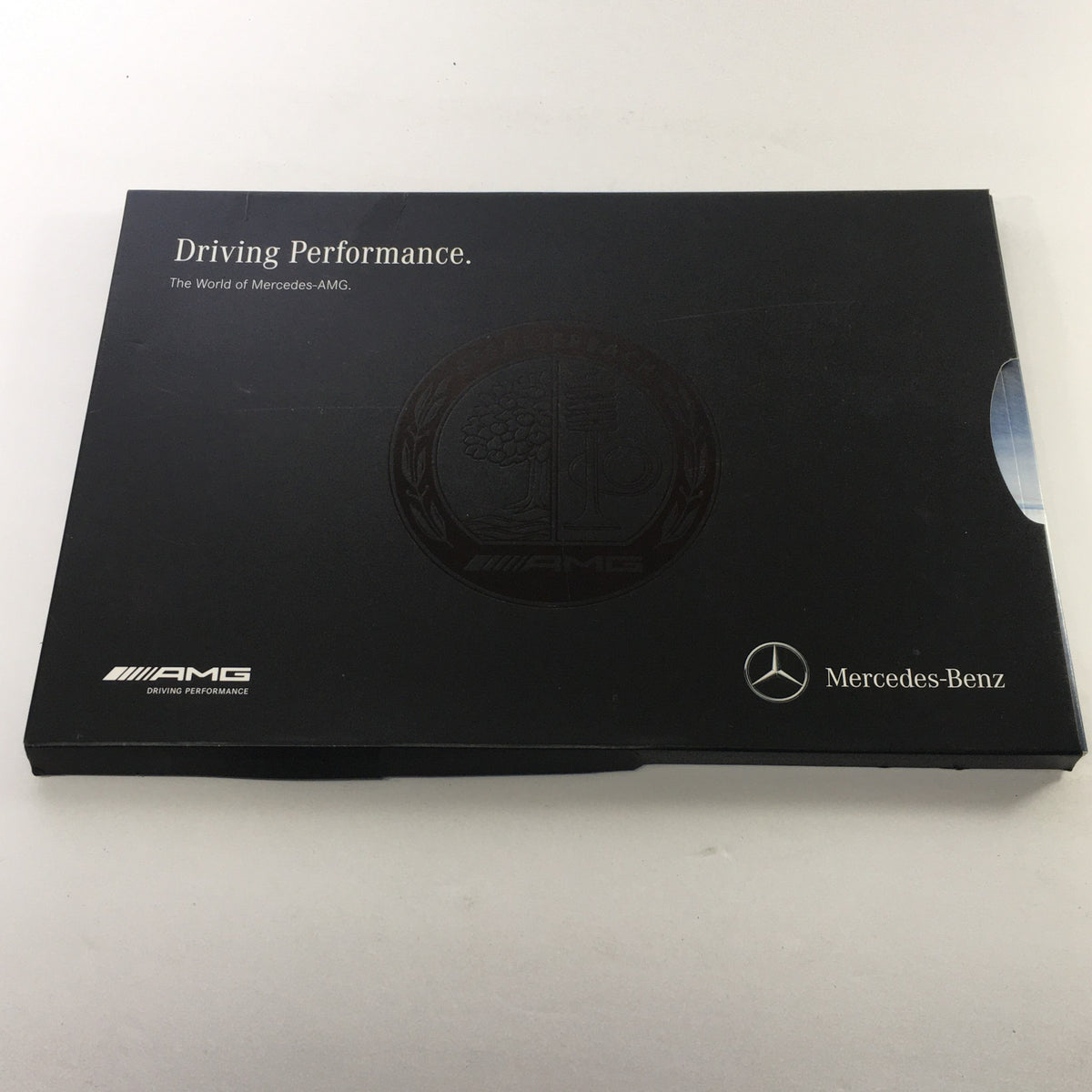 2013 Mercedes-Benz AMG Portfolio Dealership Car Auto Brochure Catalog displaying the elegant black cover with the AMG logo and text 'Driving Performance'.