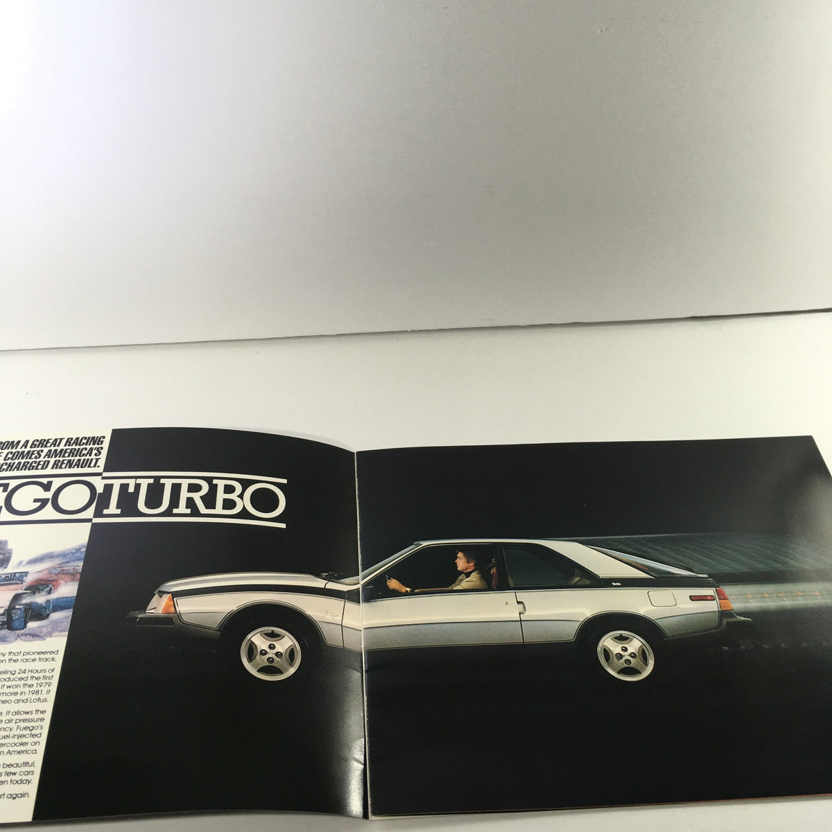 Interior page of the 1984 Renault Fuego Turbo Coupe Dealership Car Auto Brochure Catalog showcasing the Renault Fuego Turbo with a driver.