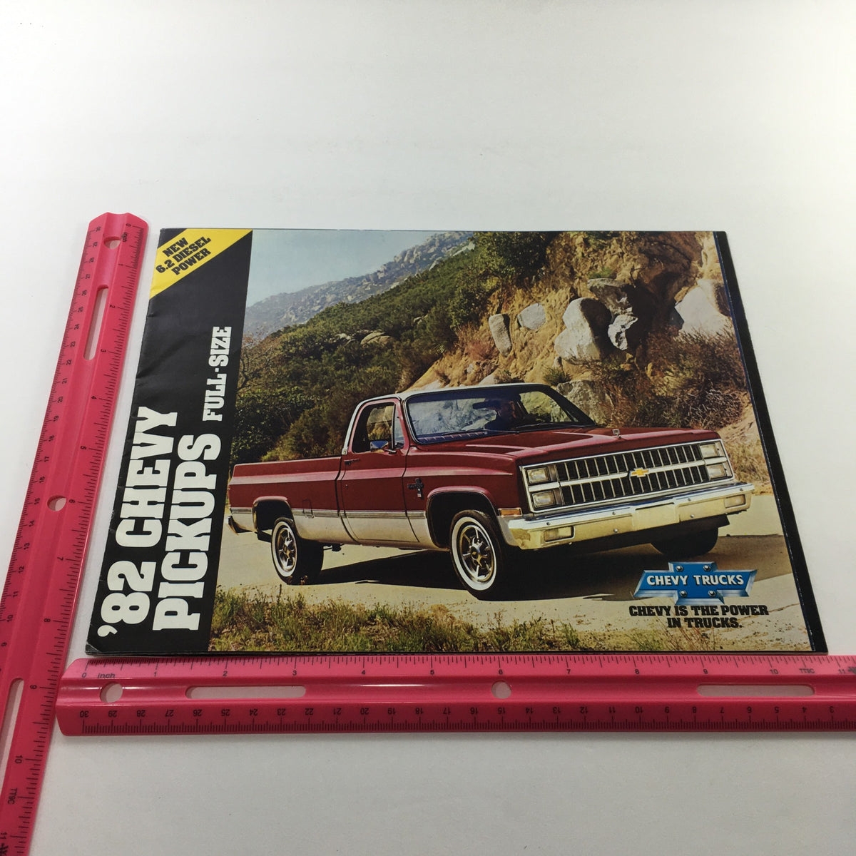 Cover of the 1982 Chevrolet Chevy Pickups Full-Size Dealership Car Auto Brochure Catalog featuring a red Chevy pickup truck on a scenic background.