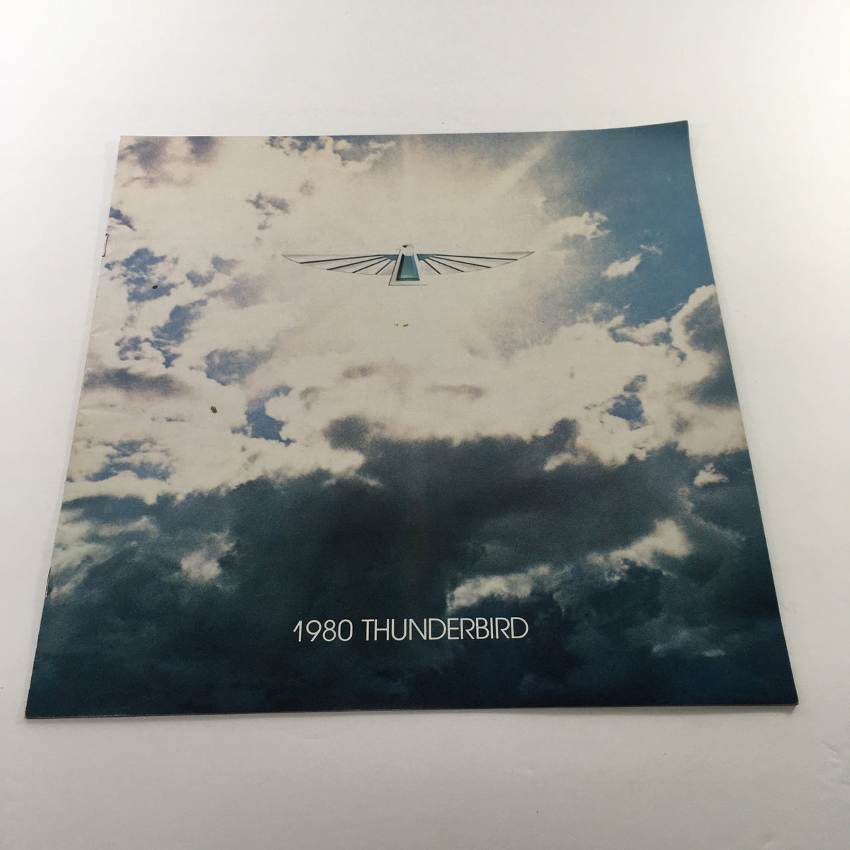 Cover of the 1980 Ford Thunderbird Dealership Car Auto Brochure Catalog showcasing dramatic clouds and the Thunderbird logo with text '1980 THUNDERBIRD'.