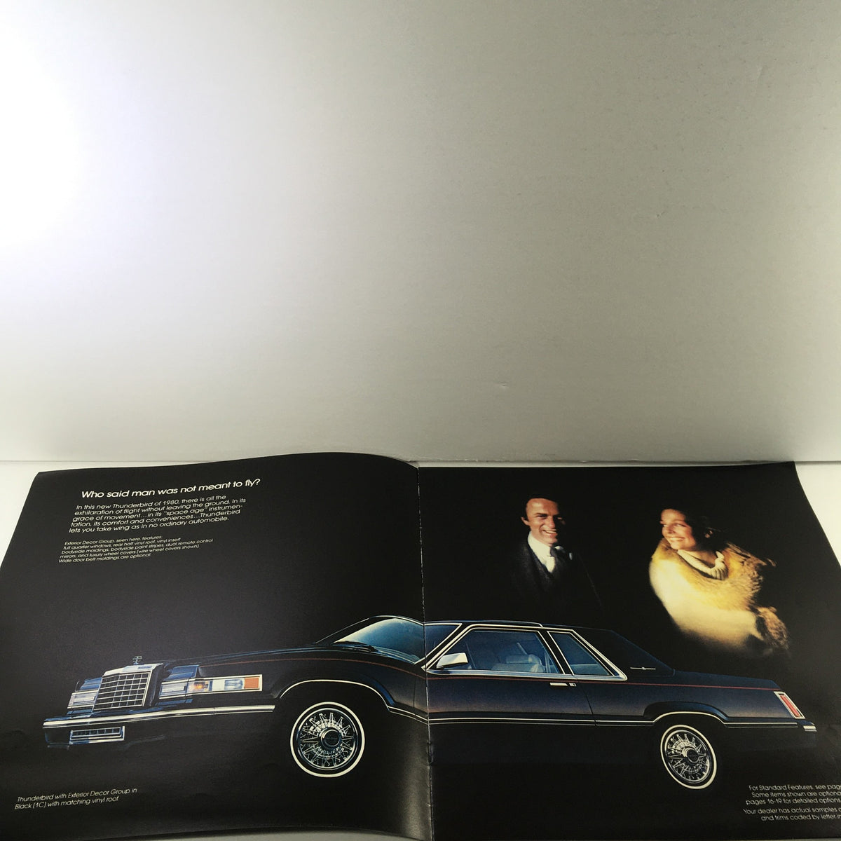 Interior page of the 1980 Ford Thunderbird Dealership Car Auto Brochure Catalog featuring the Thunderbird car model in a stylish setting alongside a couple, with engaging text about the vehicle.