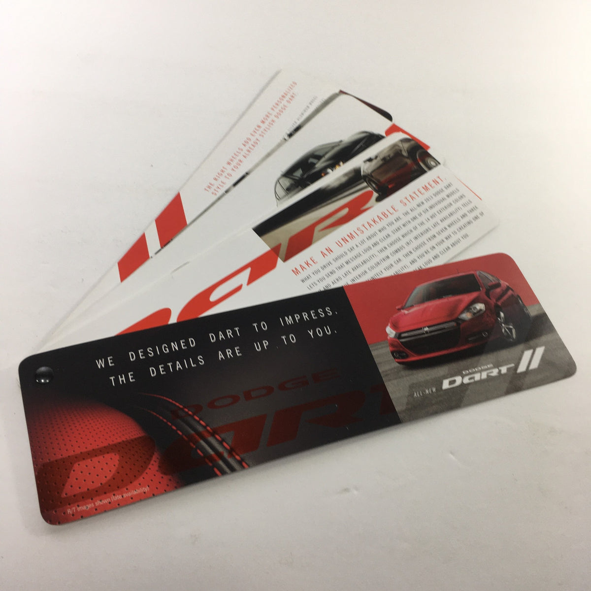2012 Dodge Dart II Dealership Car Auto Brochure Catalog showcasing multiple promotional cards with striking design elements.