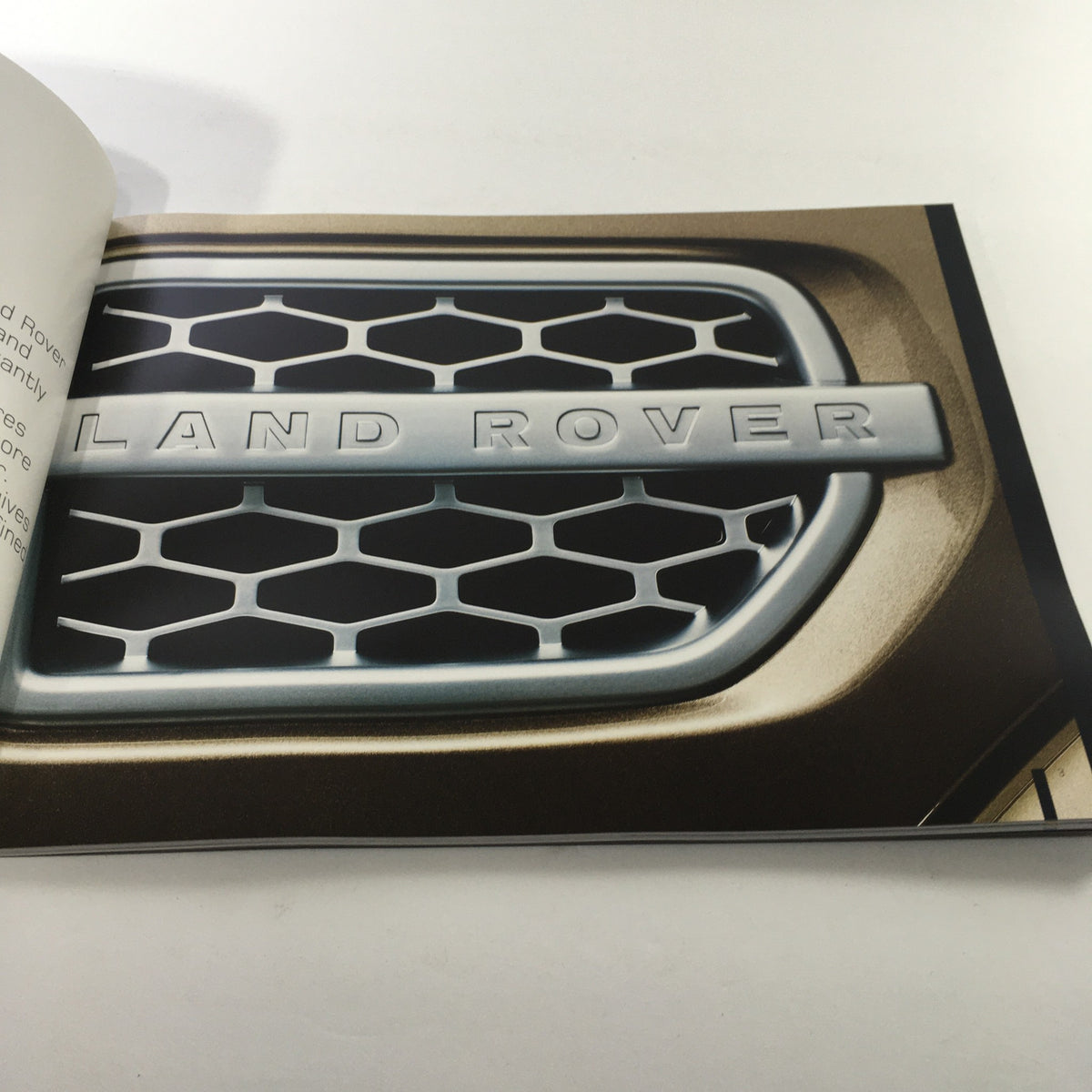 Close-up of the Land Rover logo from the 2010 Land Rover LR-4 Dealership Car Auto Brochure Catalog.