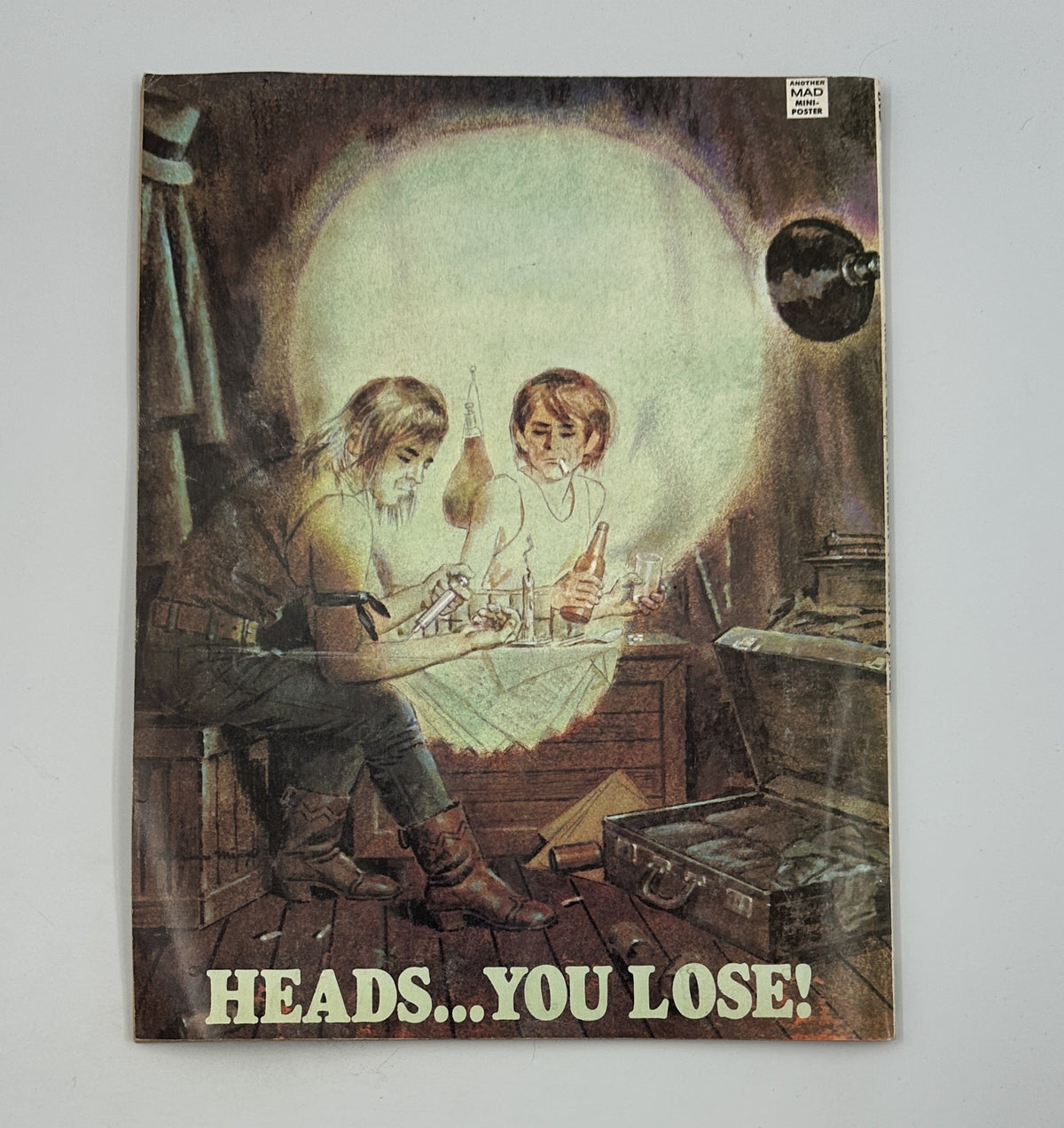 Back cover of MAD Magazine Super Special No. 23, featuring an illustration with the phrase 'HEADS... YOU LOSE!', displaying a whimsical and intriguing visual.