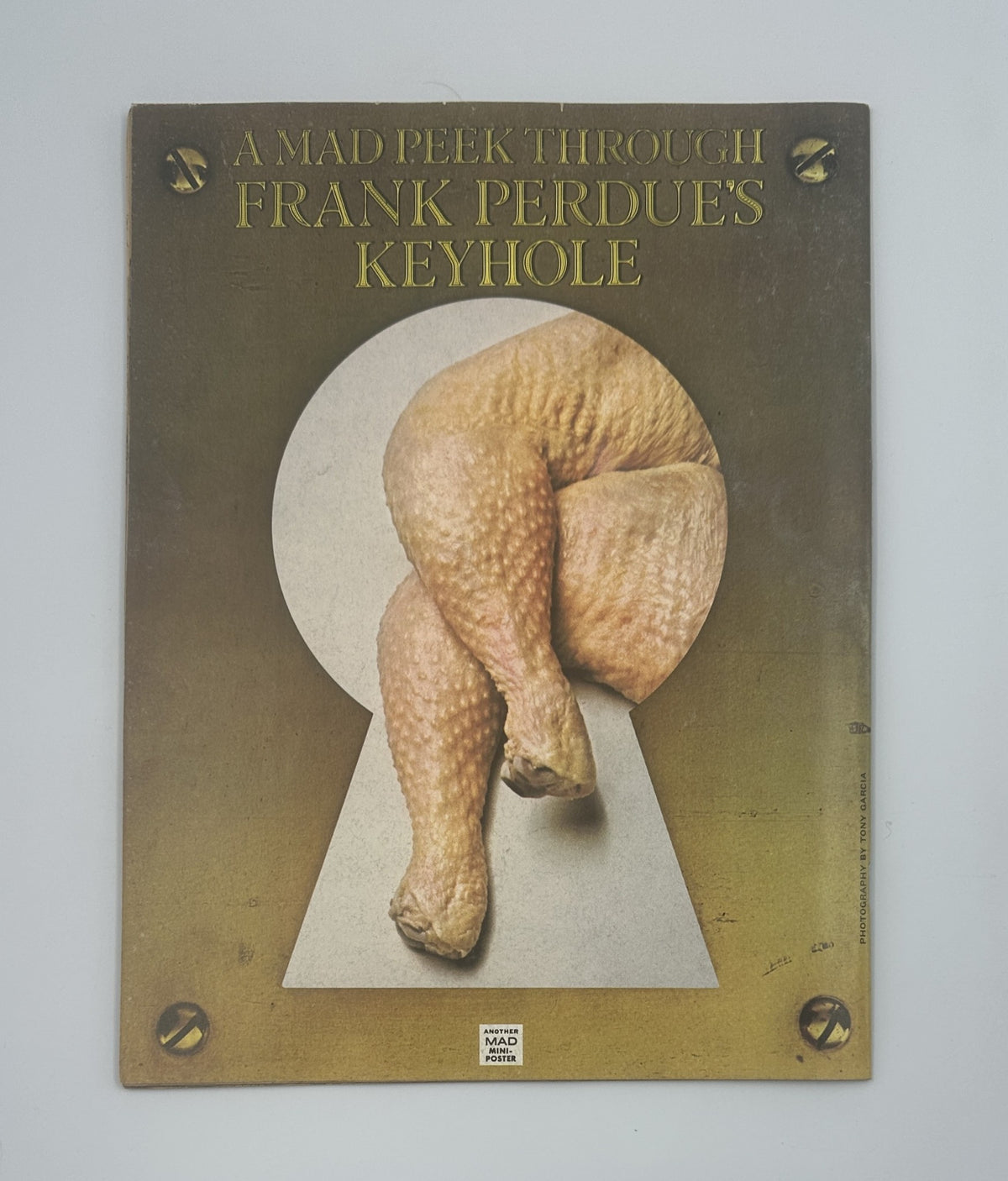 Back cover of MAD Magazine No. 180 with a humorous image titled 'A MAD Peek Through Frank Perdue's keyhole.' This vintage magazine issue is part of the renowned MAD series, appealing to comedy fans and collectors.