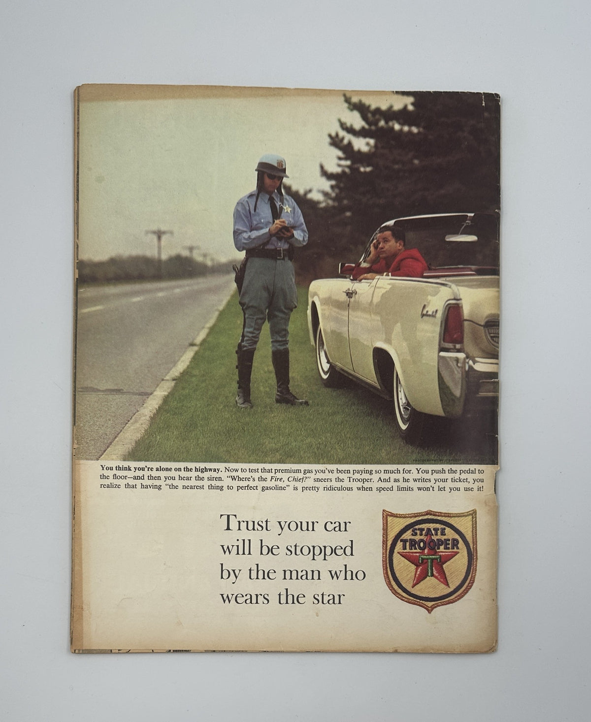 Back cover of MAD Magazine No. 82 October 1963, featuring a humorous advertisement with a State Trooper and the slogan 'Trust your car will be stopped by the man who wears the star.' Vintage humor capturing the essence of the magazine's style.