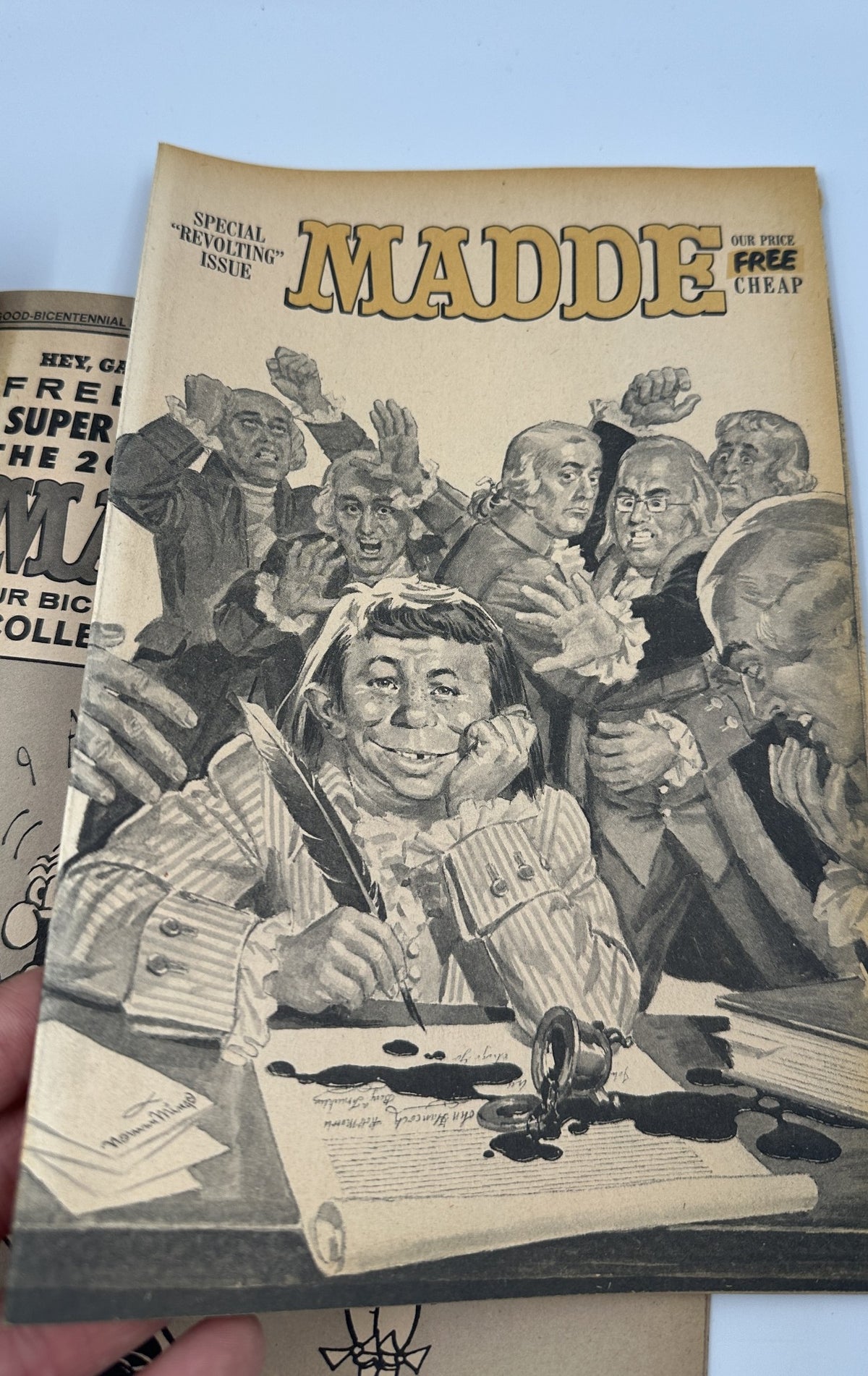 Cover of MAD Magazine Super Special 1976 No. 19 featuring a caricature of characters celebrating behind a smiling figure, showcasing the humor of the 200-Year Old MADDE Bicentennial special edition, graded Fine (FN 6.0).