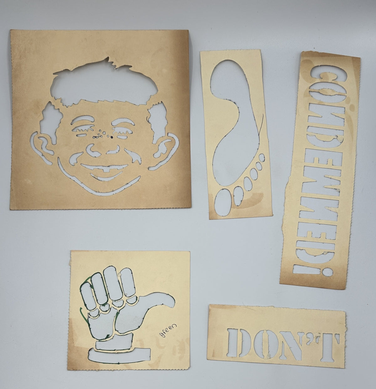 Set of five detached stencils included in MAD Magazine MAD 1967 Follies 5 Fifth Annual Collection showing various cut-out designs for creative use.