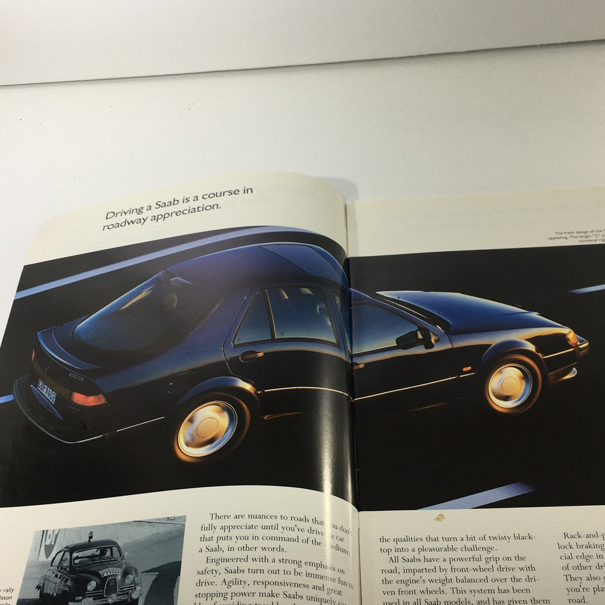 Inside view of the 1993 Saab 900 Turbo Series Dealership Car Auto Brochure, showcasing a Saab vehicle in action with the text 'Driving a Saab is a course in roadway appreciation'.