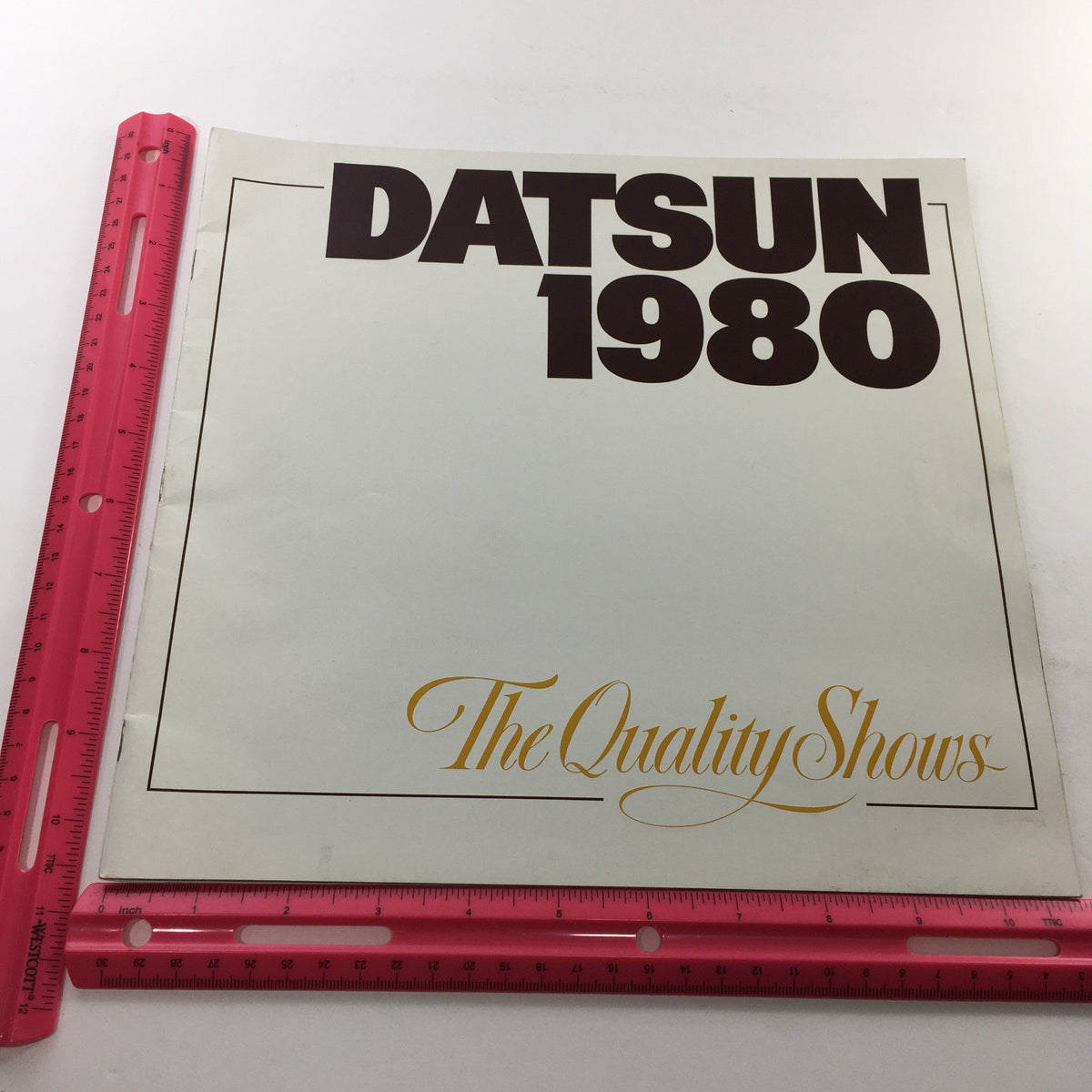 Front cover of the 1980 Datsun Quality Shows Dealership Car brochure featuring bold title 'DATSUN 1980' with elegant graphics.