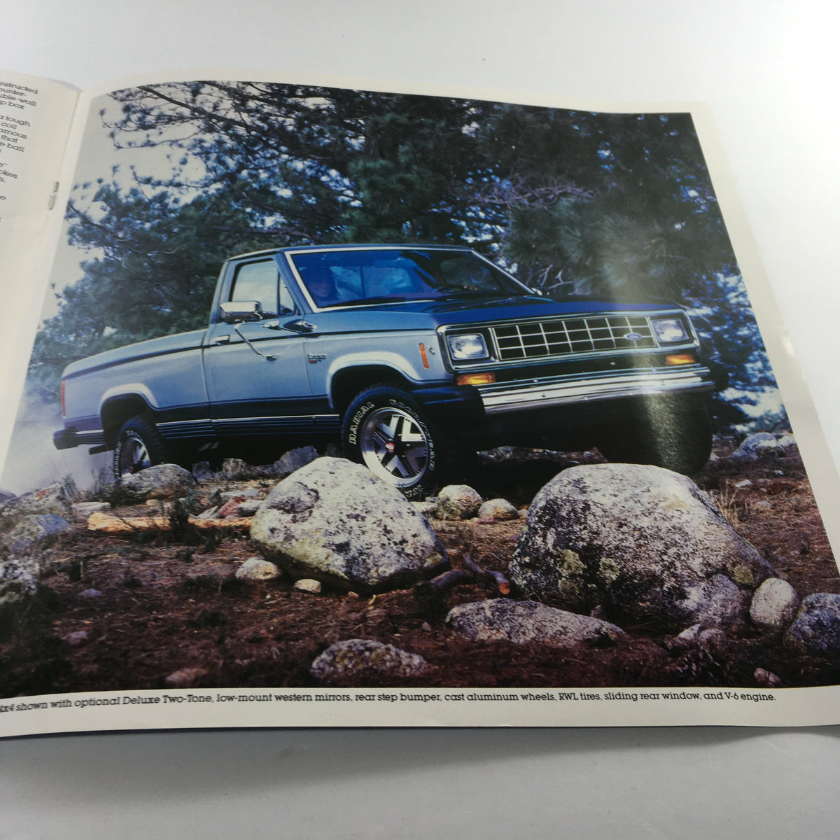Image of a 1985 Ford Ranger parked on rocky terrain, demonstrating off-road capabilities with optional features like a V6 engine.
