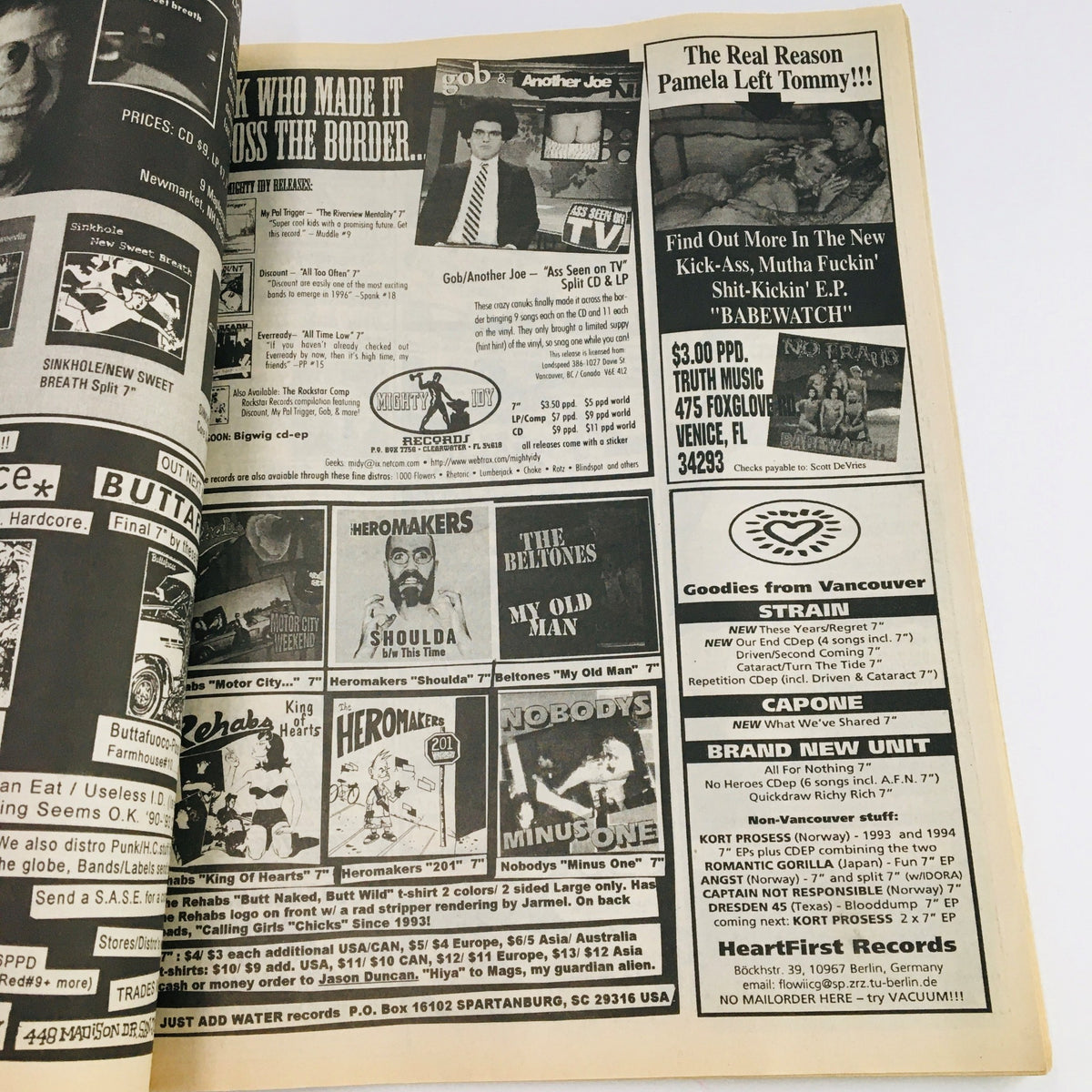 Advertisement page from Maximum RocknRoll Magazine April 1997, showcasing punk music merchandise and band promotions, reflecting the underground music culture.