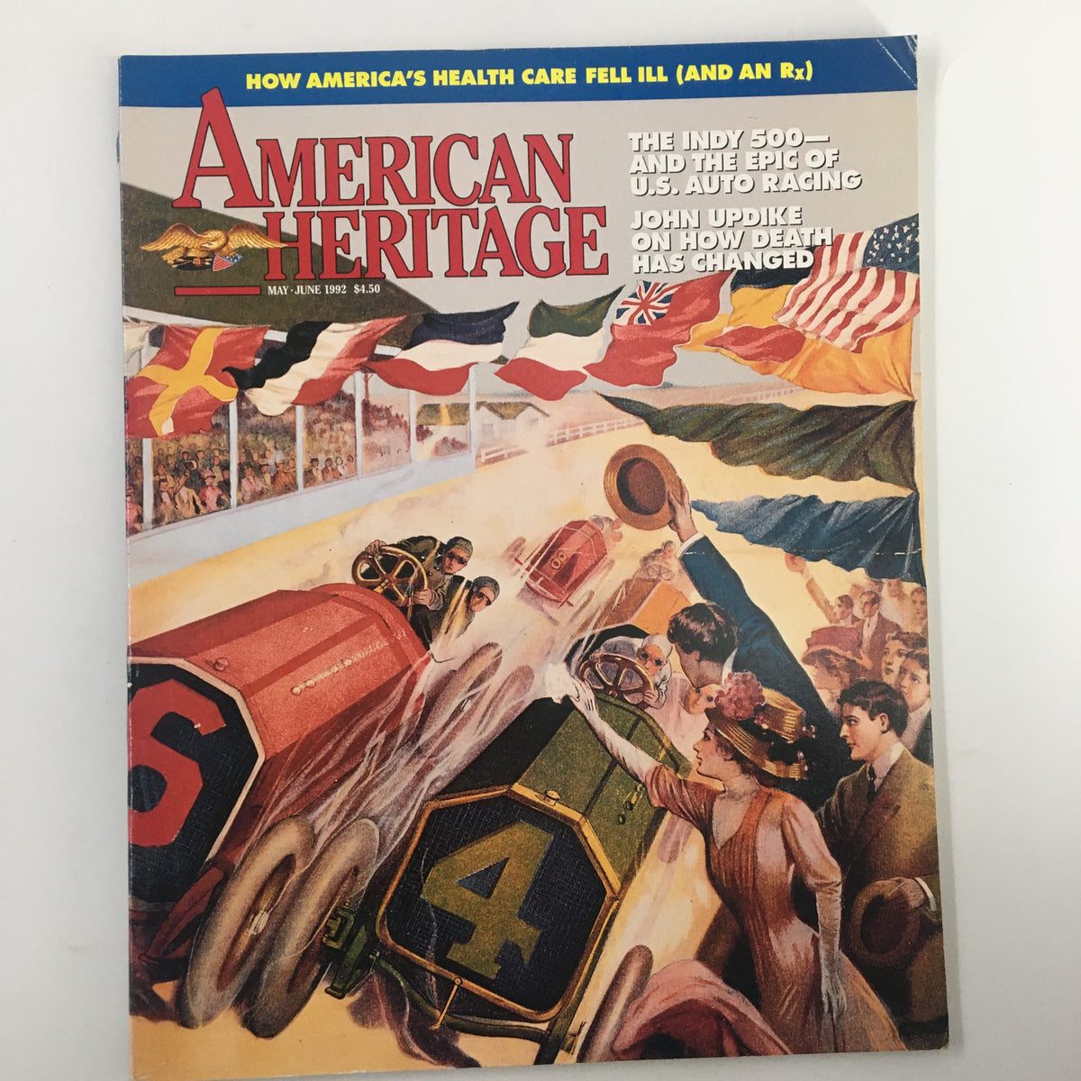 Cover of American Heritage Magazine May 1992 featuring a vibrant illustration of automobile racing at the Indy 500 with spectators and flags, highlighting the excitement of U.S. auto racing.