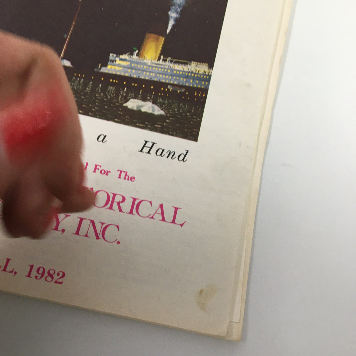 Close-up view of 'The Titanic Commutator' magazine cover Fall 1982 edition titled 'Fate Deals a Hand' with hand partially covering the title.