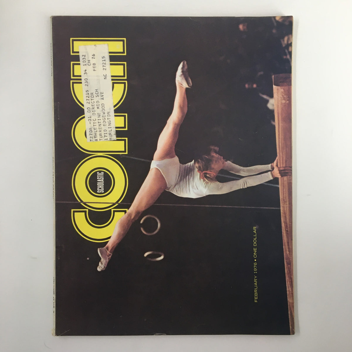 Cover of the VTG Scholastic Coach Magazine February 1976 featuring the incomparable Olga Korbut performing an athletic pose, highlighting the magazine's focus on gymnastics.