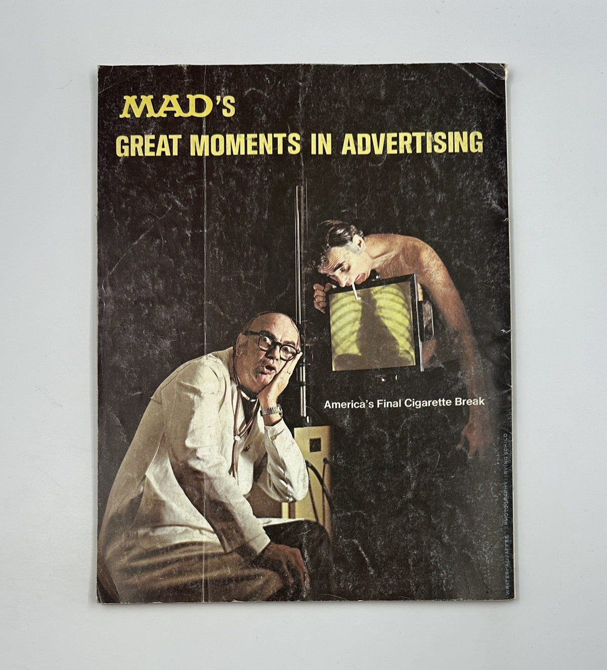 Cover of MAD's Great Moments in Advertising showcasing satirical take on advertising, highlighting humorous commentary on cigarette advertising in America.