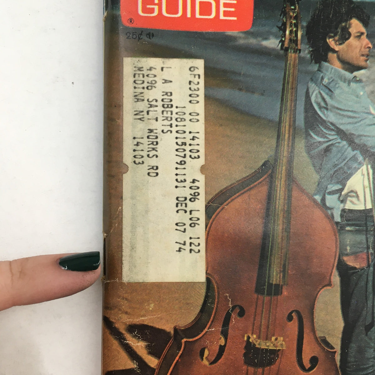Close-up image of the TV Guide from September 28, 1974, featuring a vintage address label on the cover, including the title 'TV Guide September 28 1974 Paul Sand Cover by Ivan Nagy Rochester NY'. The magazine showcases a nostalgic design and light wear typical for its age.