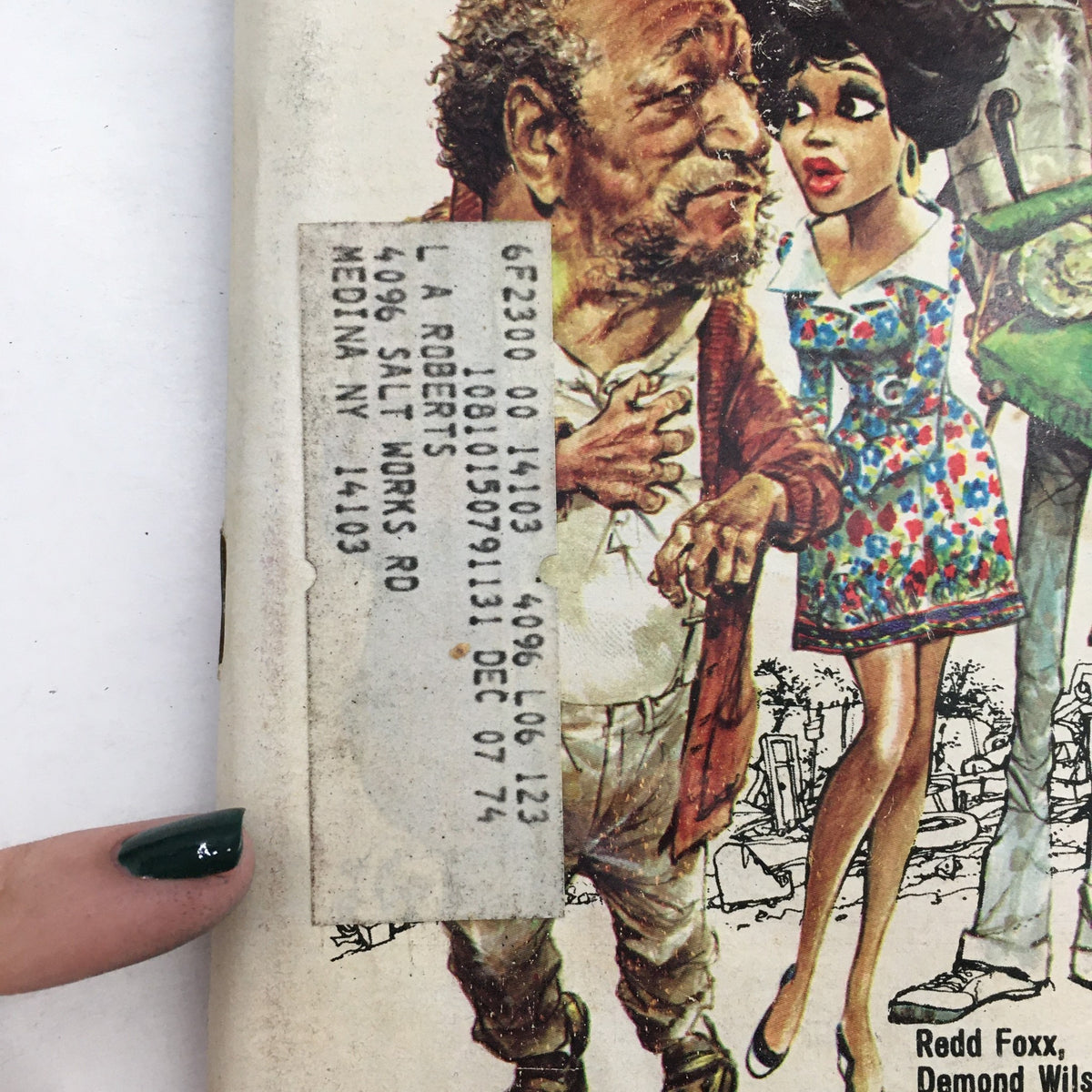 A close-up of a TV Guide Magazine from October 5, 1974 showcasing characters Redd Foxx and Demond Wilson, including an address label and artistic representation of the characters.