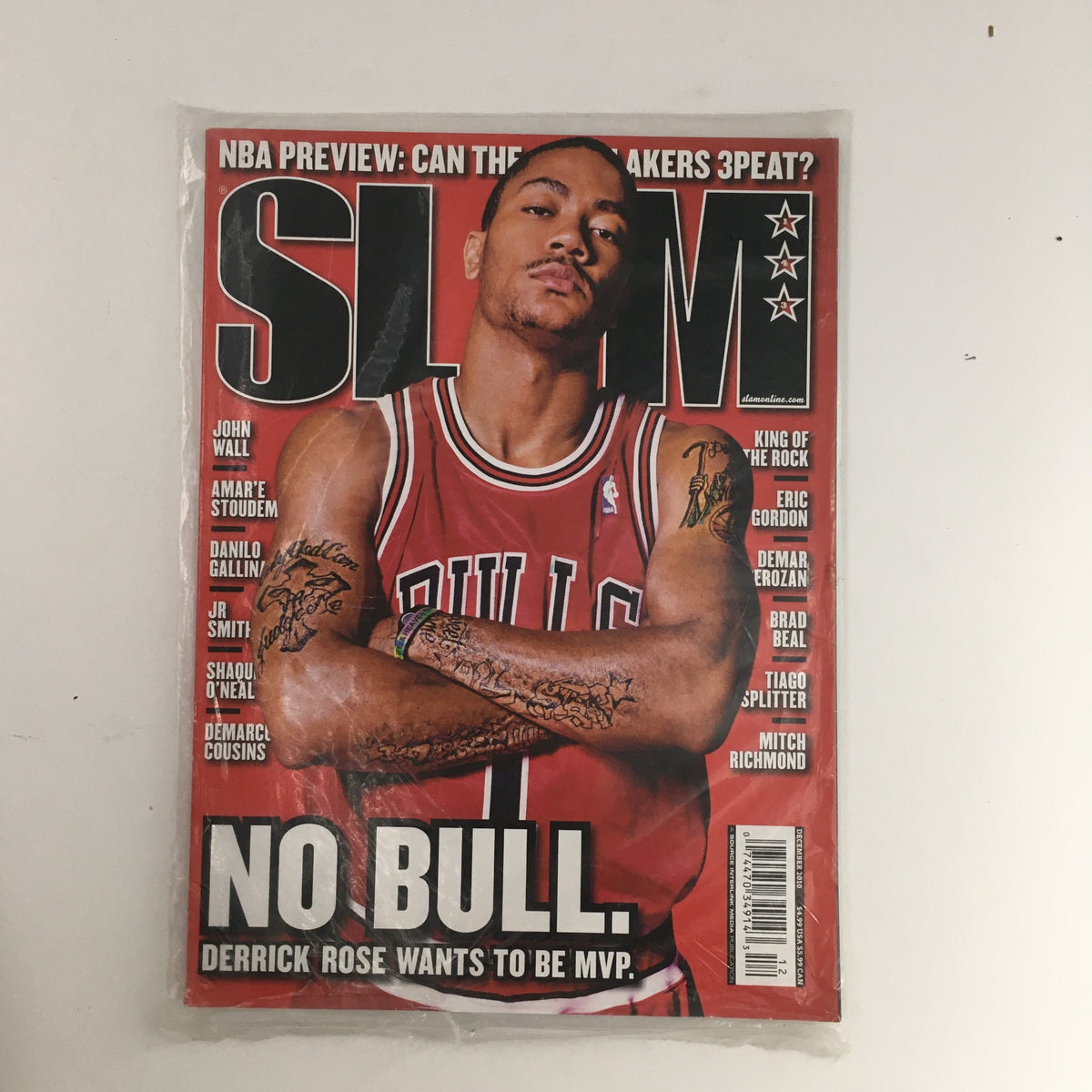 Slam Magazine December 2010 #143 featuring Derrick Rose on the cover, showcasing a vintage basketball collectible, highlighting his MVP aspirations with the Chicago Bulls.