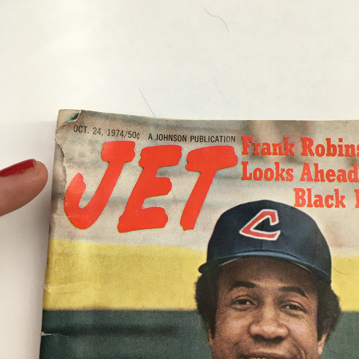 Close-up of the Jet Magazine from October 24, 1974, highlighting the title 'JET' and featuring Frank Robinson's name as the first Black manager, with visible wear on the magazine cover.