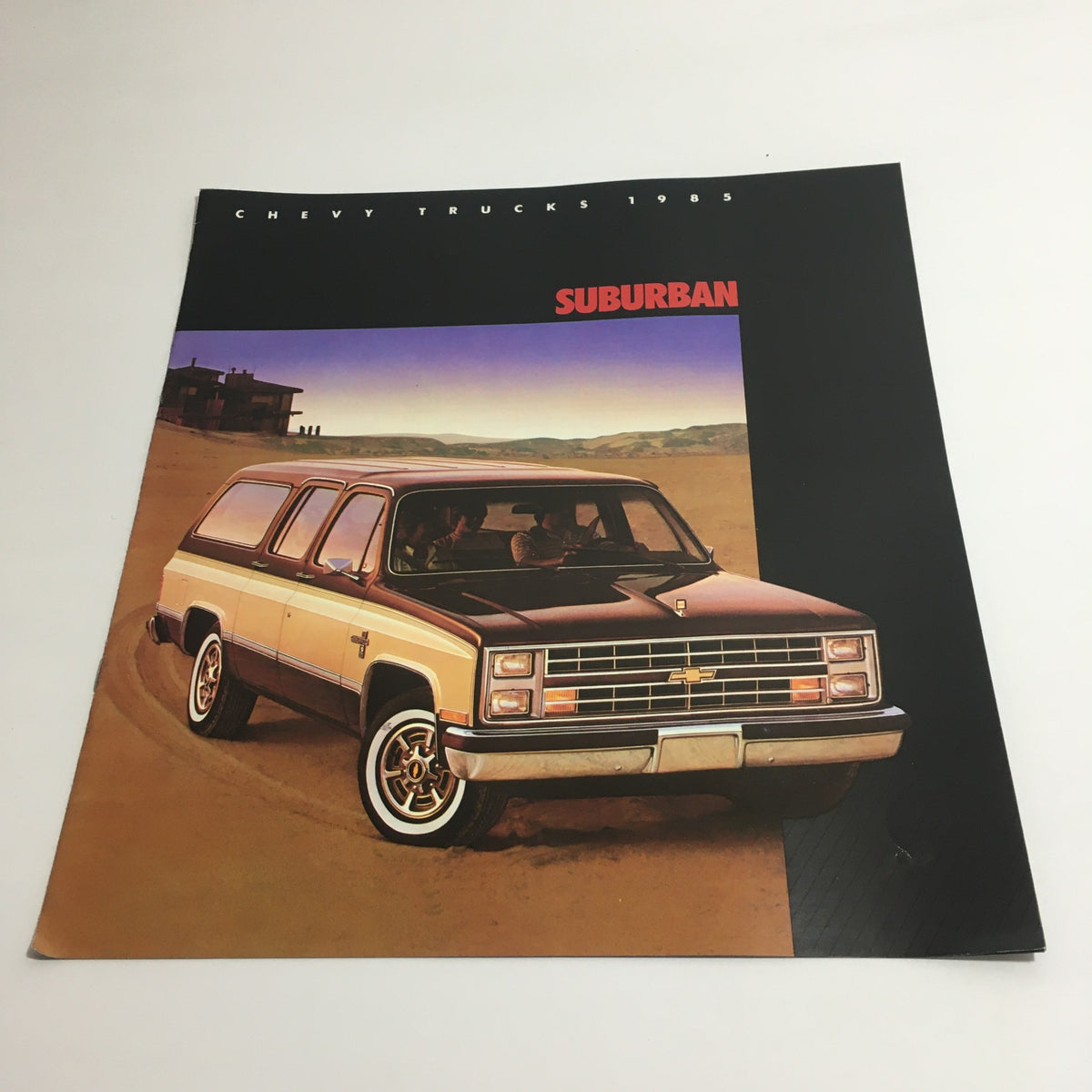 Cover of the 1985 Chevy Trucks Full-Size Blazer Dealership Brochure Catalog featuring a Chevy Suburban parked in a desert landscape.