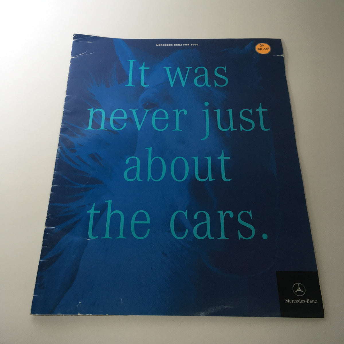 Cover of the 2000 Mercedes-Benz CLK-Class S-Class Dealership Catalog Brochure featuring text 'It was never just about the cars' on a blue background.
