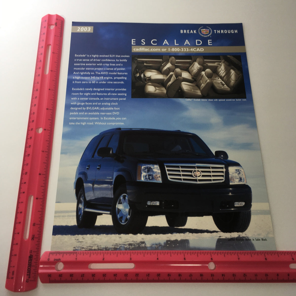 2003 Cadillac Escalade Break Through SUV promotional brochure featuring an image of the SUV, enhanced interior details, and various exterior color options.