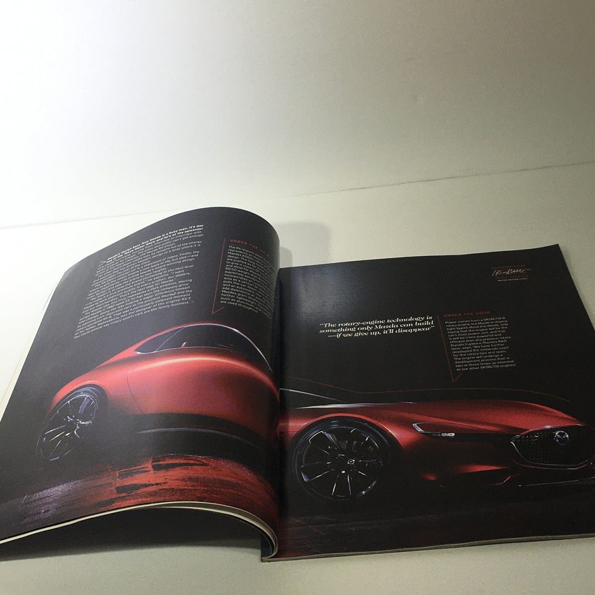 Spring 2016 Mazda RX-Vision CX-9 Debuts dealership car catalog brochure featuring a striking photo of the Mazda RX-Vision in a magazine layout, highlighting its sleek design.