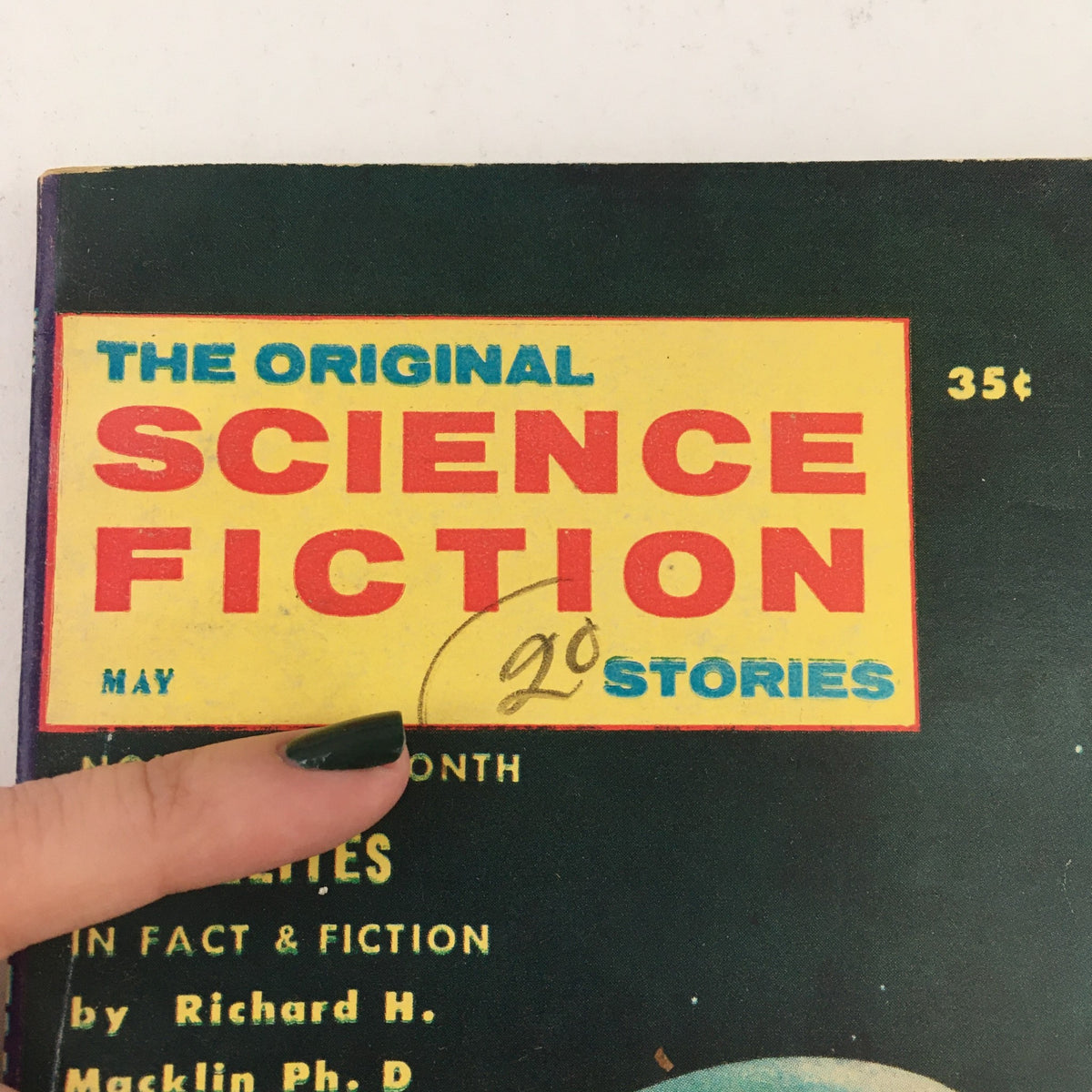 Close-up of the title section on the cover of The Original Science Fiction Stories May 1958, highlighting the magazine's name and price, featuring notable stories including The Tower of Zanid.