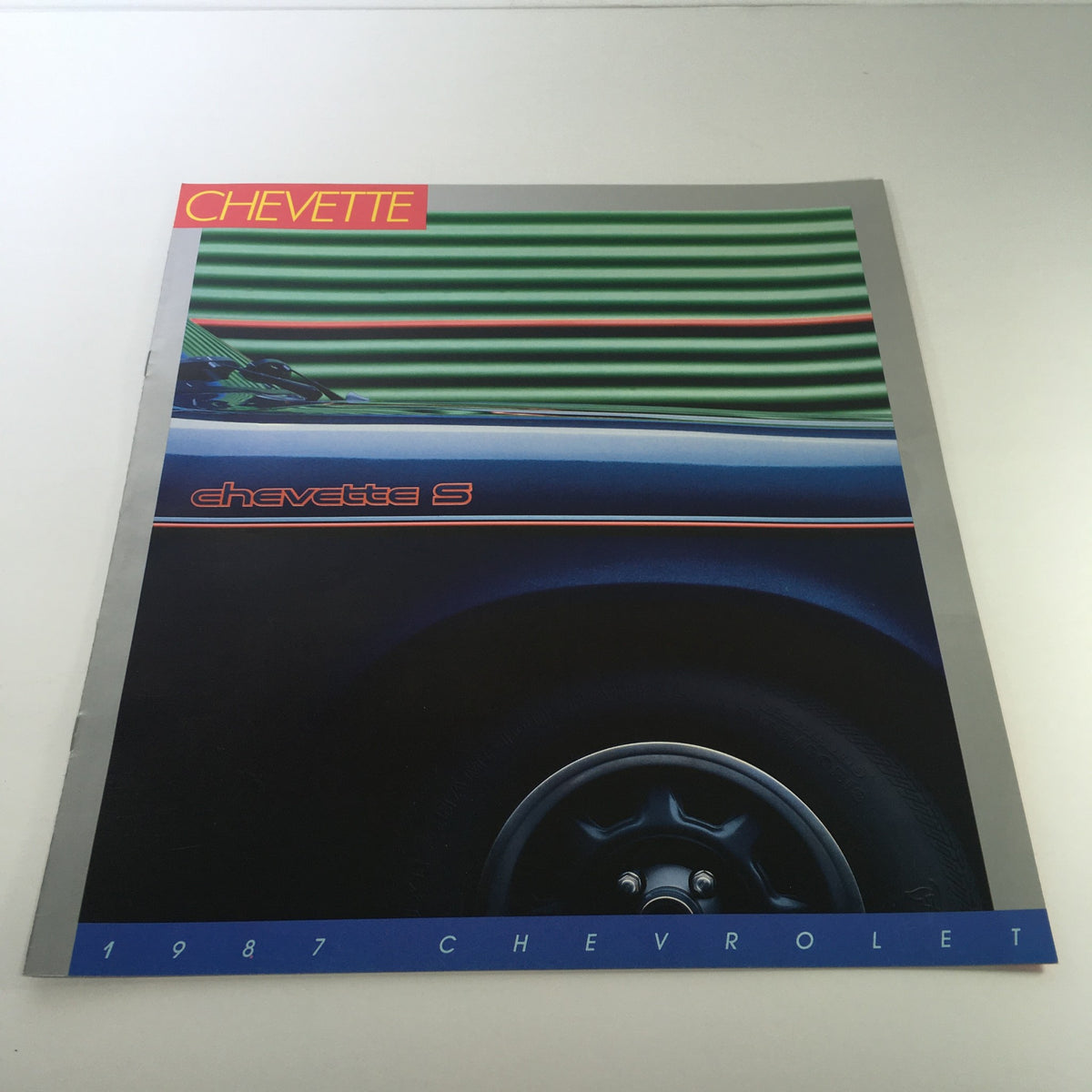1987 Chevrolet Chevette S brochure featuring a vibrant design with a close-up of the vehicle, included in a lot of 8 dealership car brochure catalogs.