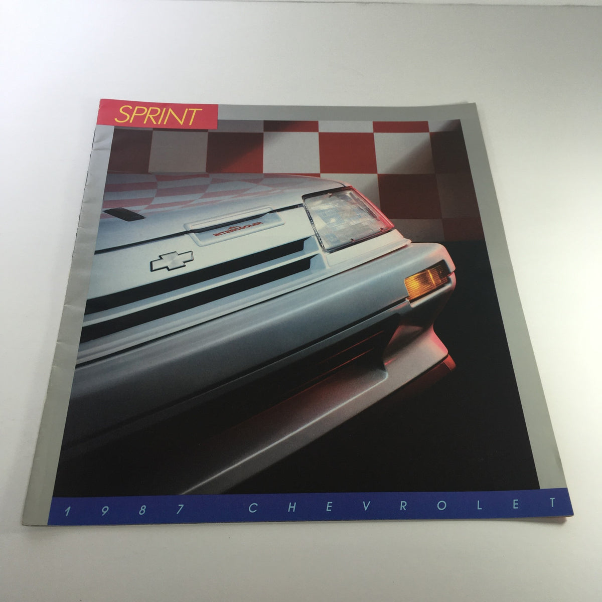 1987 Chevrolet Sprint brochure displaying a striking image of the car's front design, included in a lot of 8 dealership car brochure catalogs.