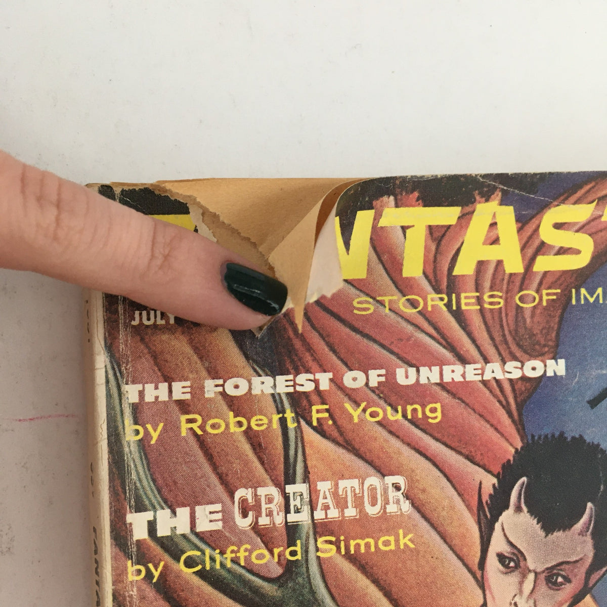 Close-up of the cover of Fantastic Science Fiction, Fantasy Stories July 1961 showing a corner tear and highlighting 'The Creator' by Clifford Simak.