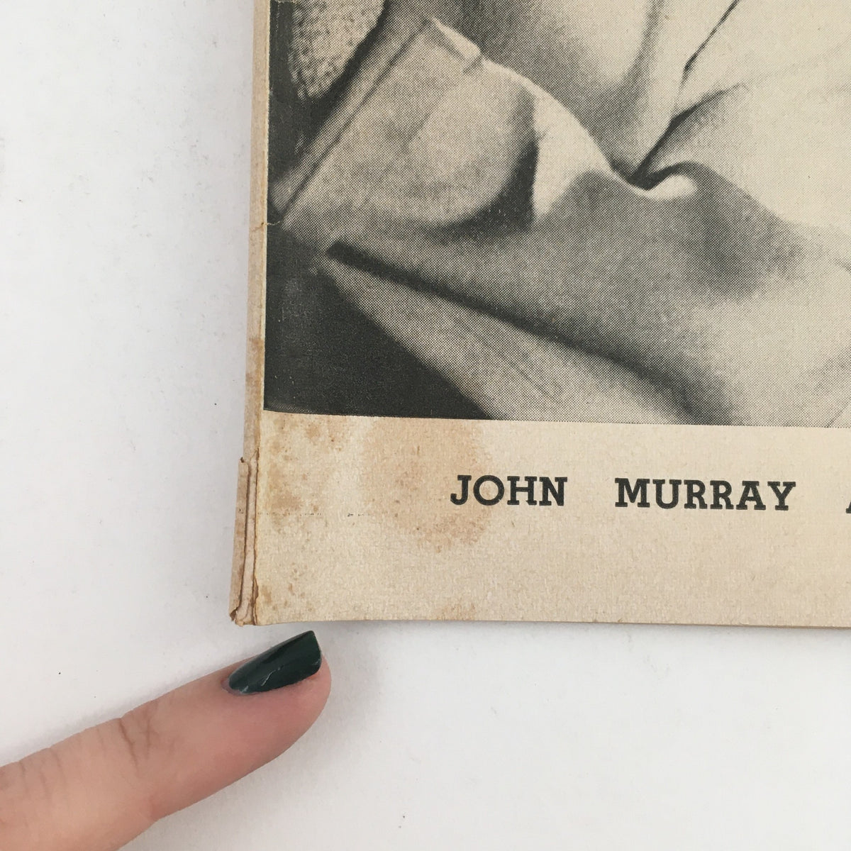 Close-up of the edge of the 1954 Playbill for John Murray Anderson's Almanac, highlighting minor wear and vintage condition, indicative of its history.