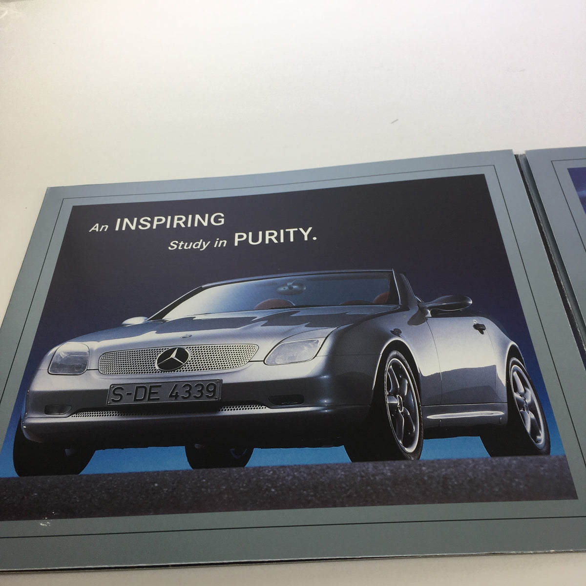 1994 Mercedes-Benz SLK Design Studies Brochure displaying a sleek silver convertible with the caption 'An INSPIRING Study in PURITY'.
