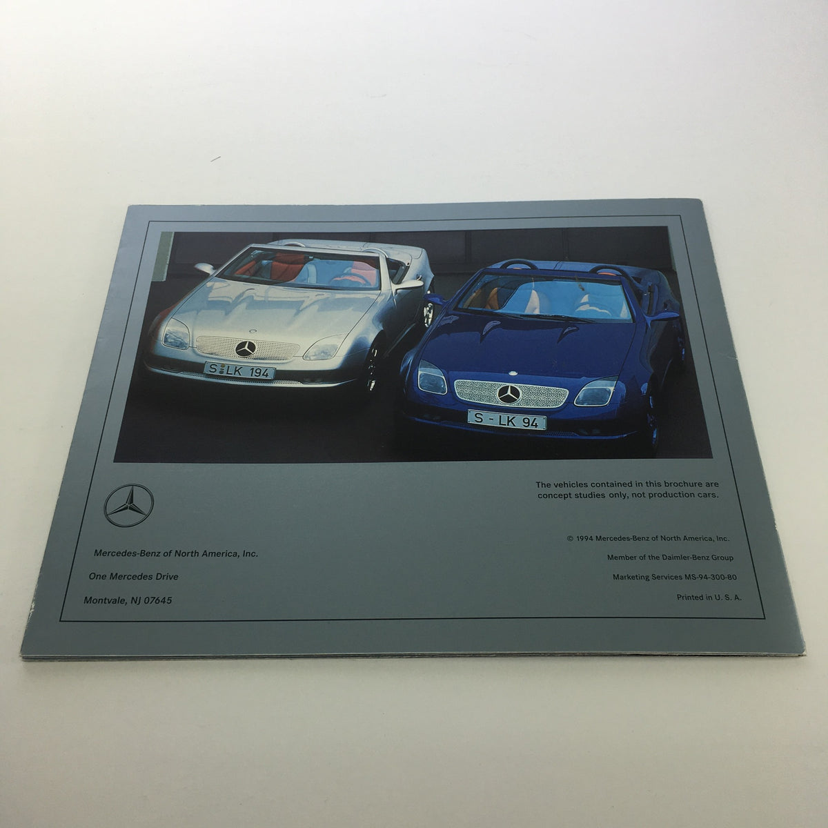 1994 Mercedes-Benz SLK Design Studies brochure image of two concept cars parked side by side, one silver and one blue.