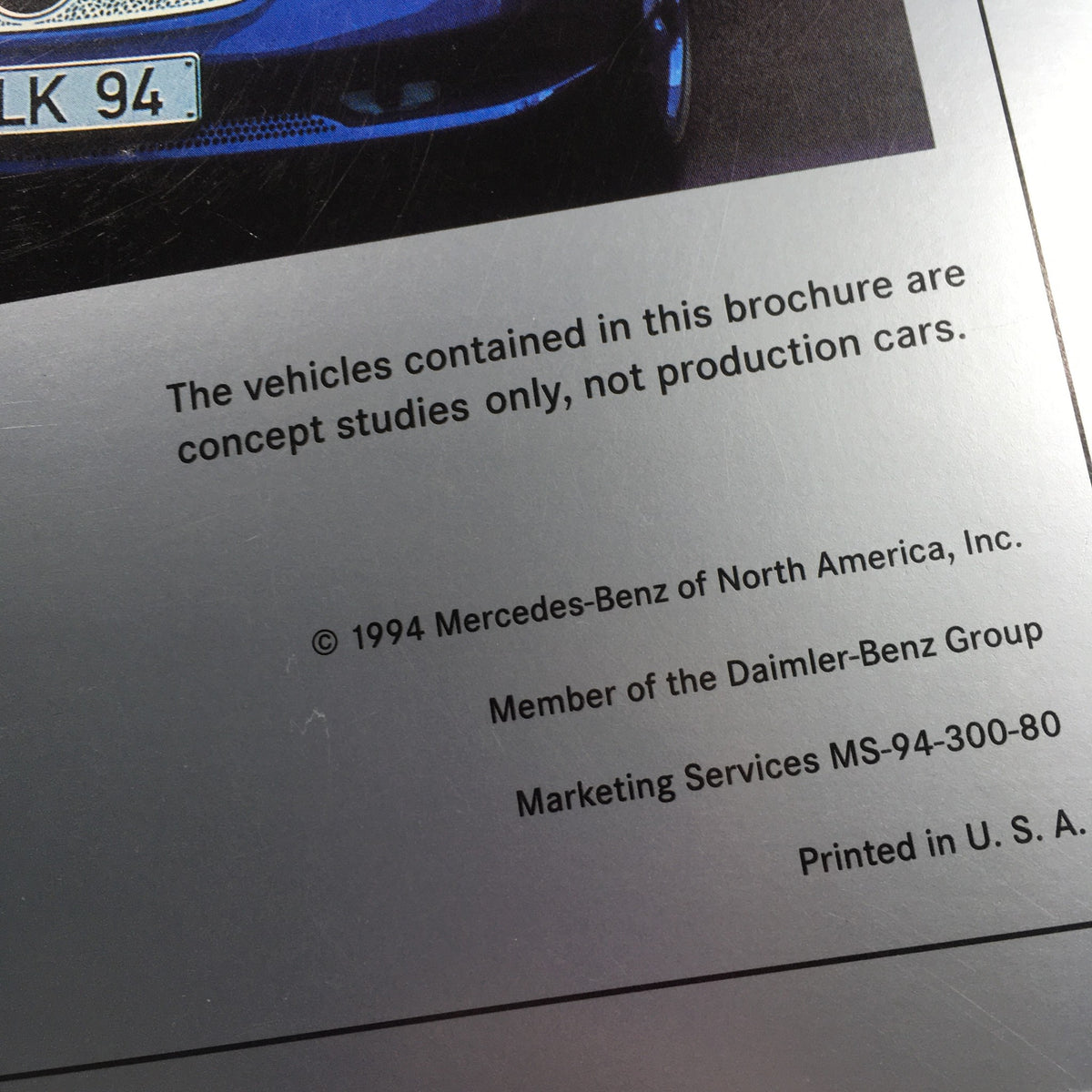 Close-up of the back cover of the 1994 Mercedes-Benz SLK Design Studies brochure, highlighting details about concept models and the Mercedes-Benz Group.