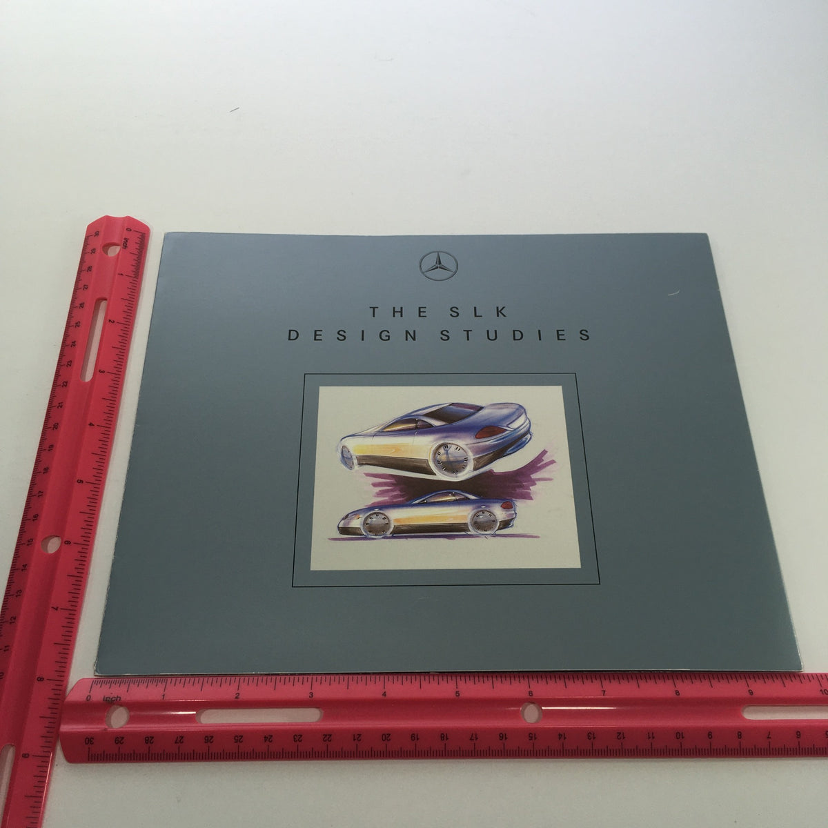 1994 Mercedes-Benz SLK Design Studies Dealership Car Auto Brochure Catalog featuring an artistic rendering of the SLK design on the cover, accompanied by a ruler for size reference.