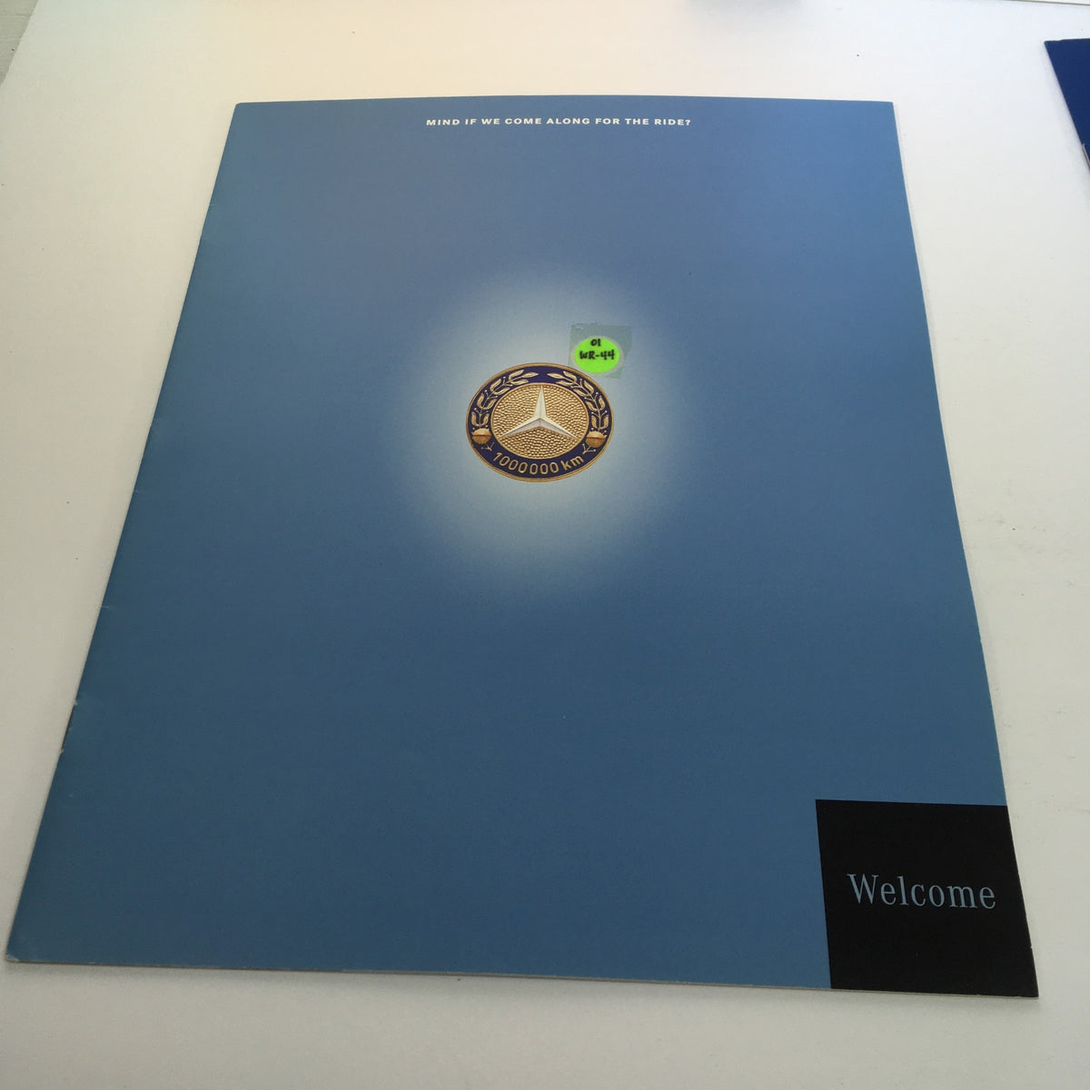 2000 Mercedes-Benz Welcome Lease and Finance The Collection Dealership Catalog featuring a blue cover with a prominent automotive emblem and the word 'Welcome', indicating an invitation to the dealership experience.