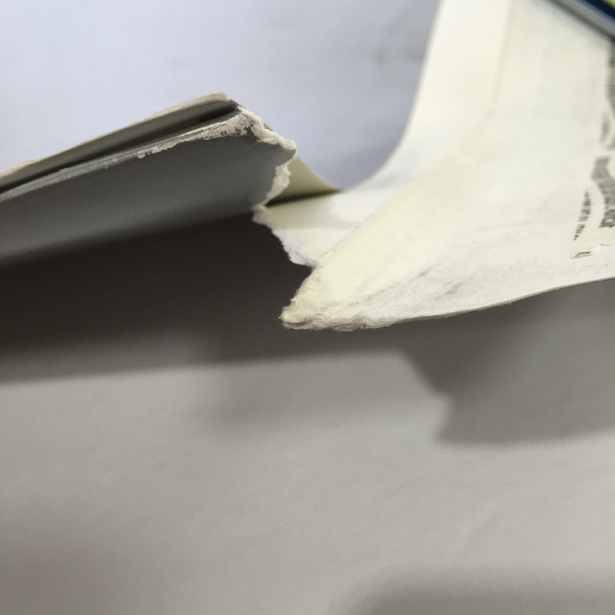 Close-up of the binding of the 2000 Mercedes-Benz Welcome Lease and Finance The Collection Dealership Catalog, highlighting the wear on the edges and sides of the catalog.
