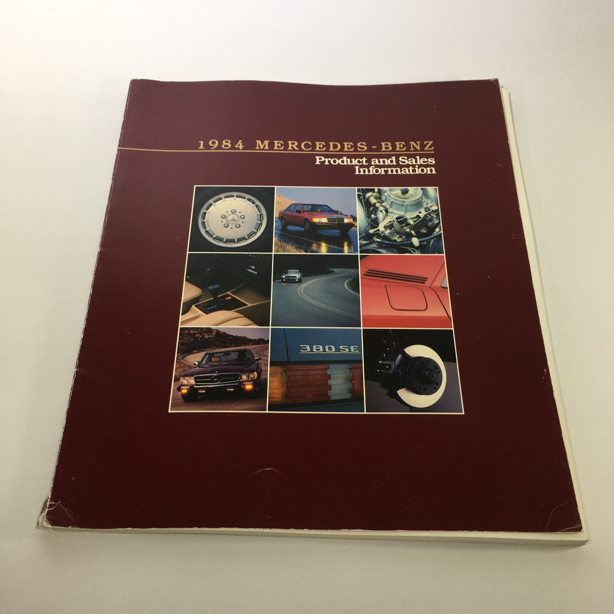 Cover of the 1984 Mercedes-Benz 190-Class Product and Sales Information Catalog featuring a collage of vehicle images including wheels, interiors, and engines.